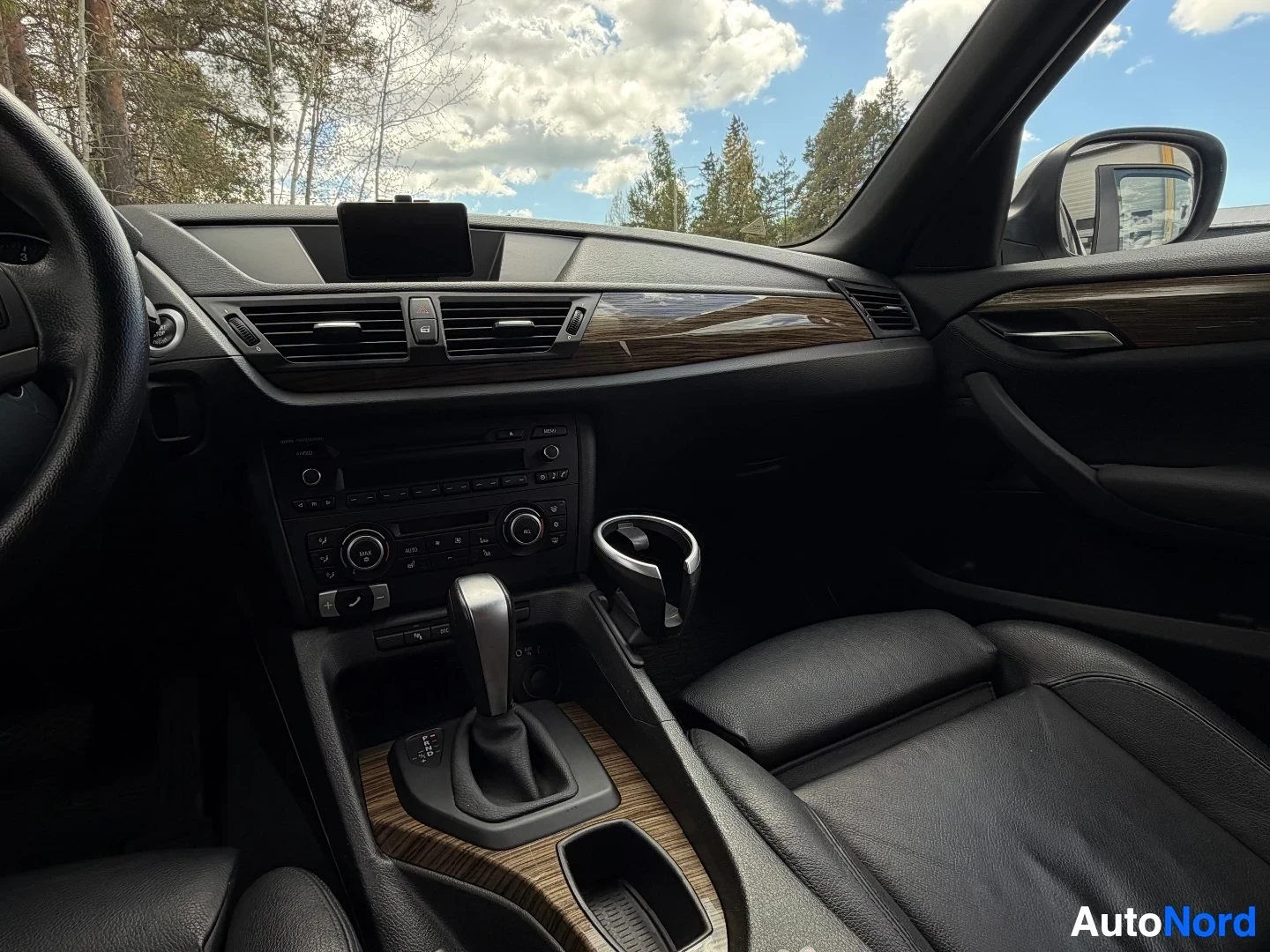 Dashboard with wood trim accents, steering wheel, and center console details