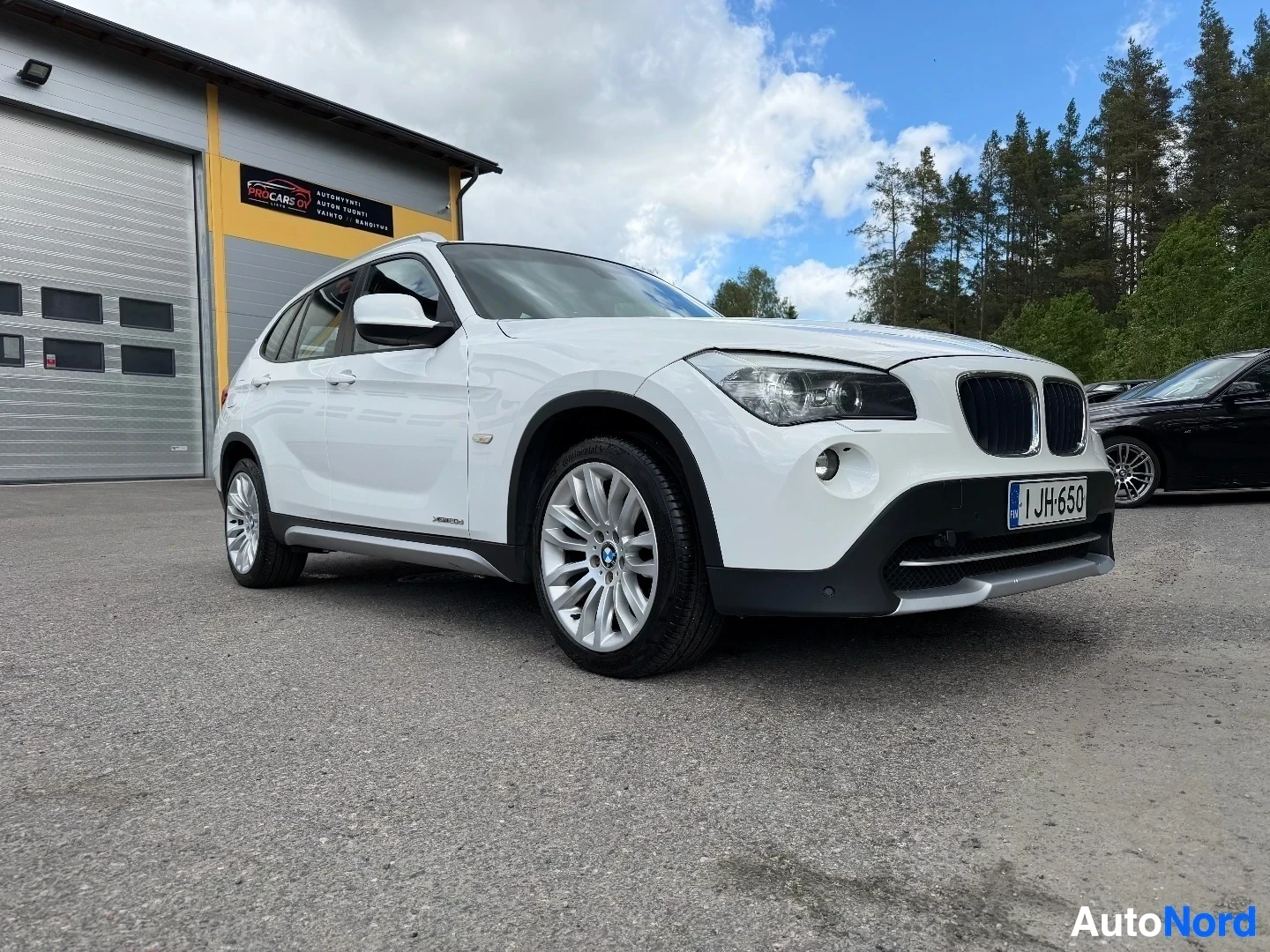 White BMW X1 SUV side view showing profile and wheels