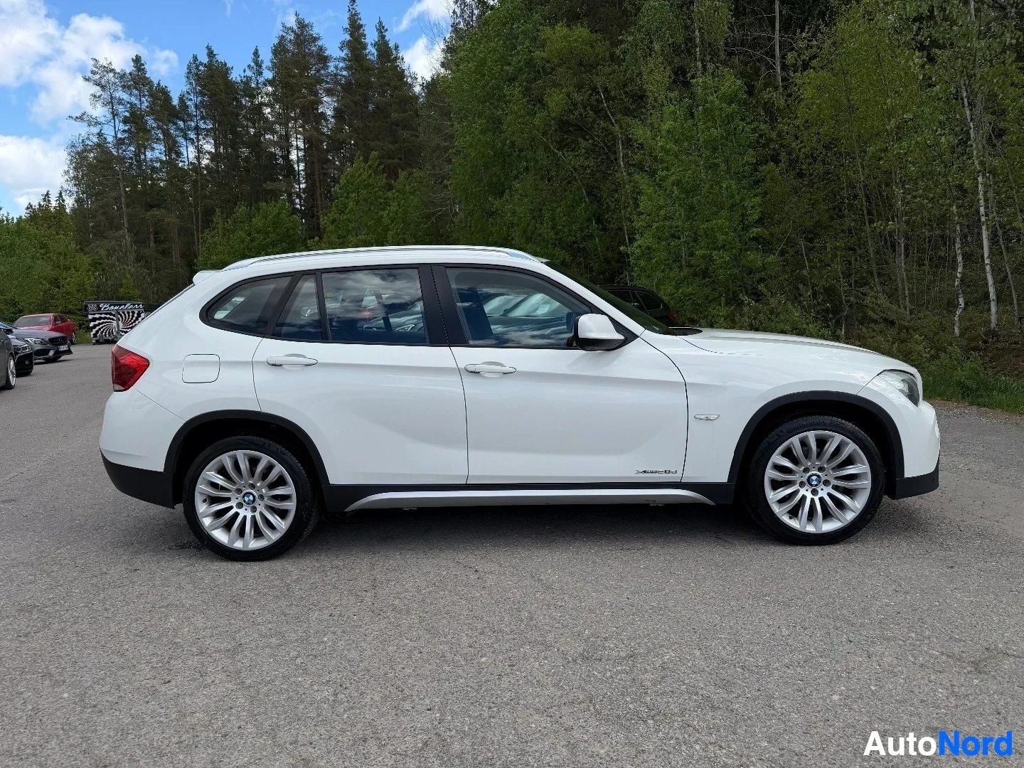 White BMW X1 SUV complete side profile view outdoors