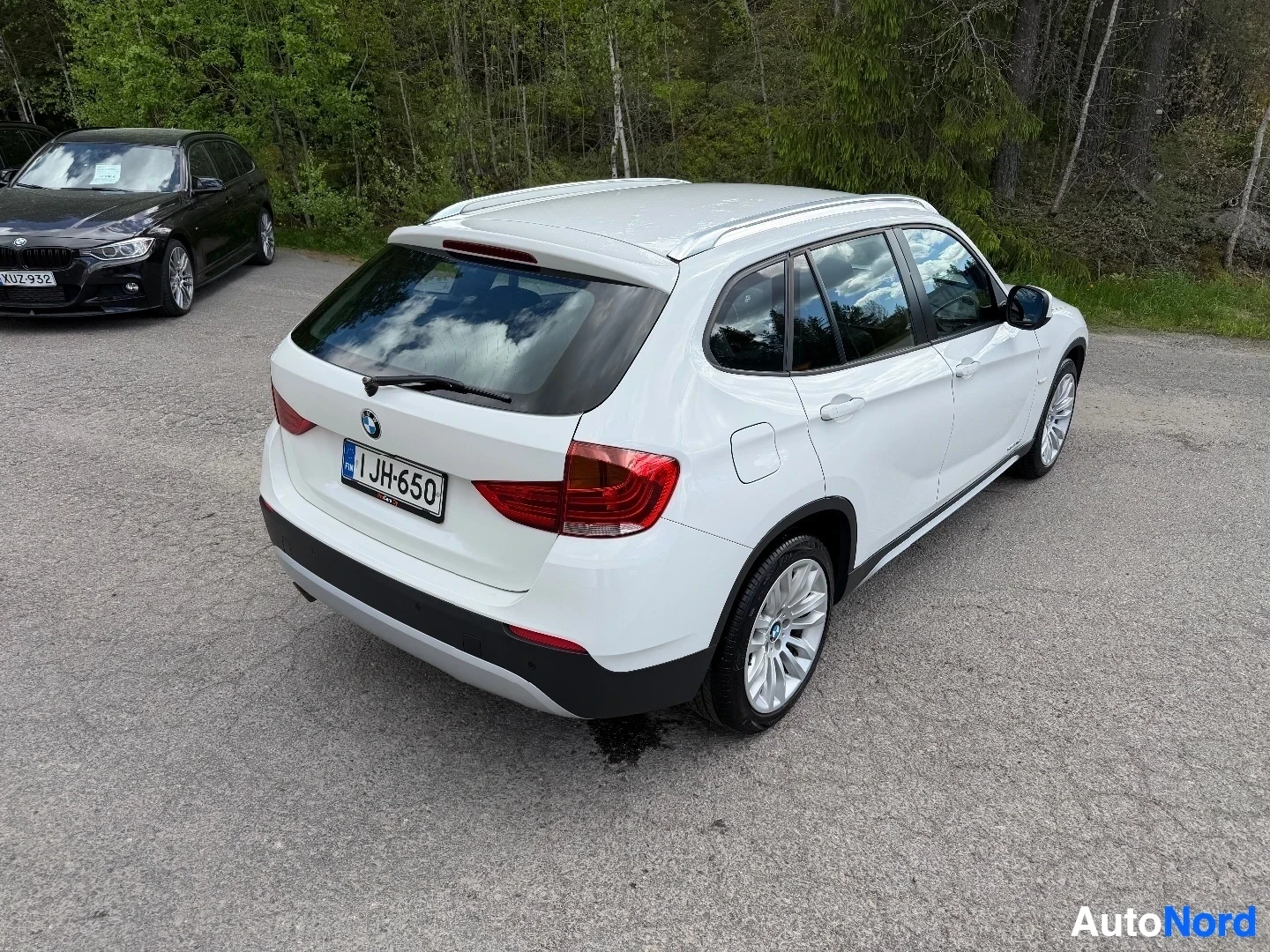 White BMW X1 SUV rear three-quarter view on asphalt