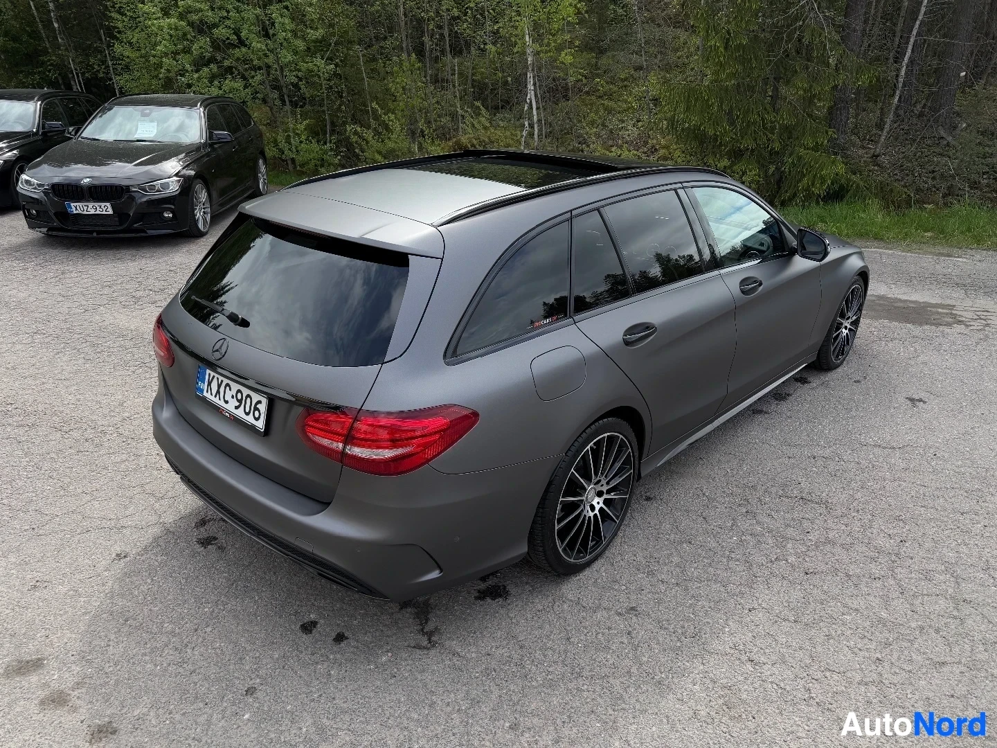 Grey Mercedes-Benz station wagon photographed from rear three-quarter angle