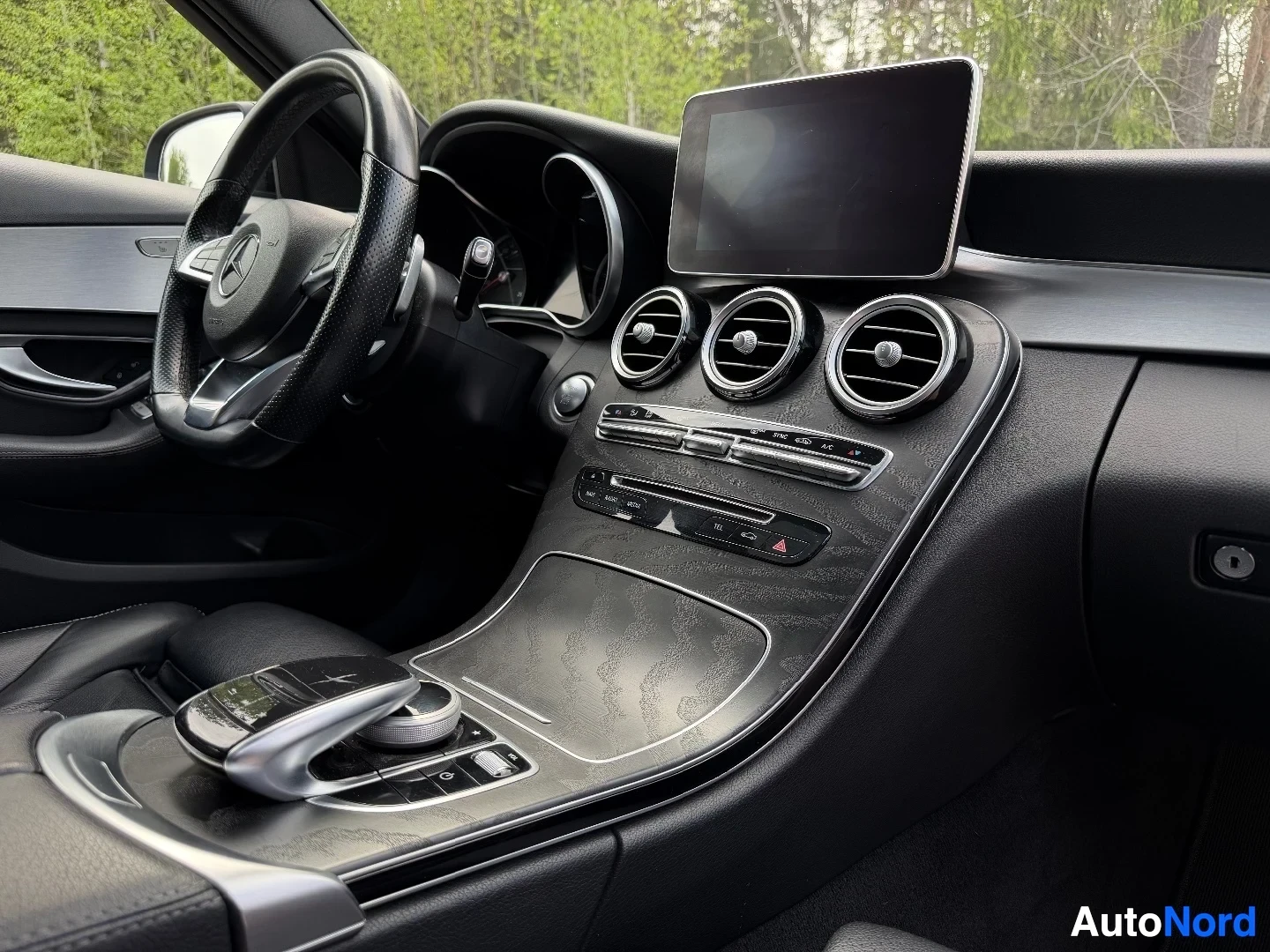 Dashboard with display screen, air vents, and center console controls