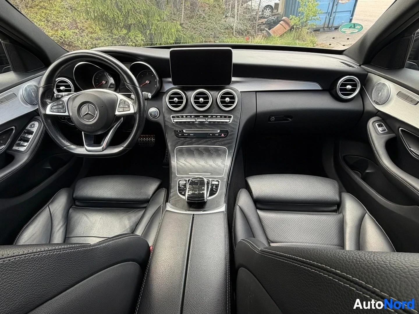 Full interior view from front showing steering wheel, dashboard and seats