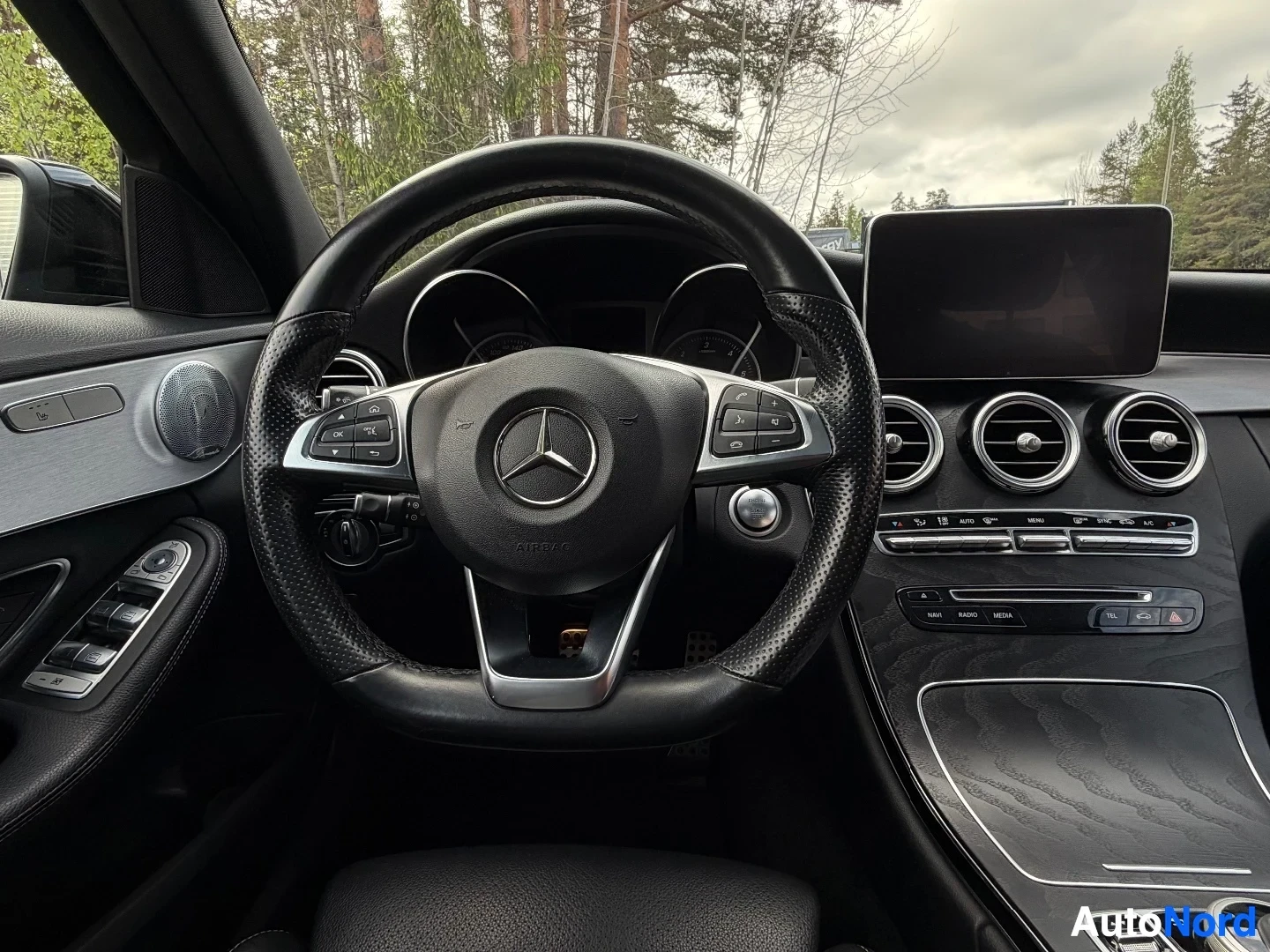 Steering wheel with Mercedes logo and digital dashboard display