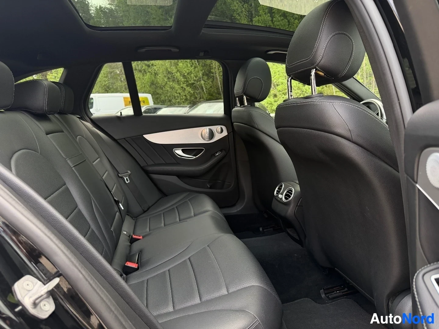 Rear seat area with black leather upholstery and headrests visible