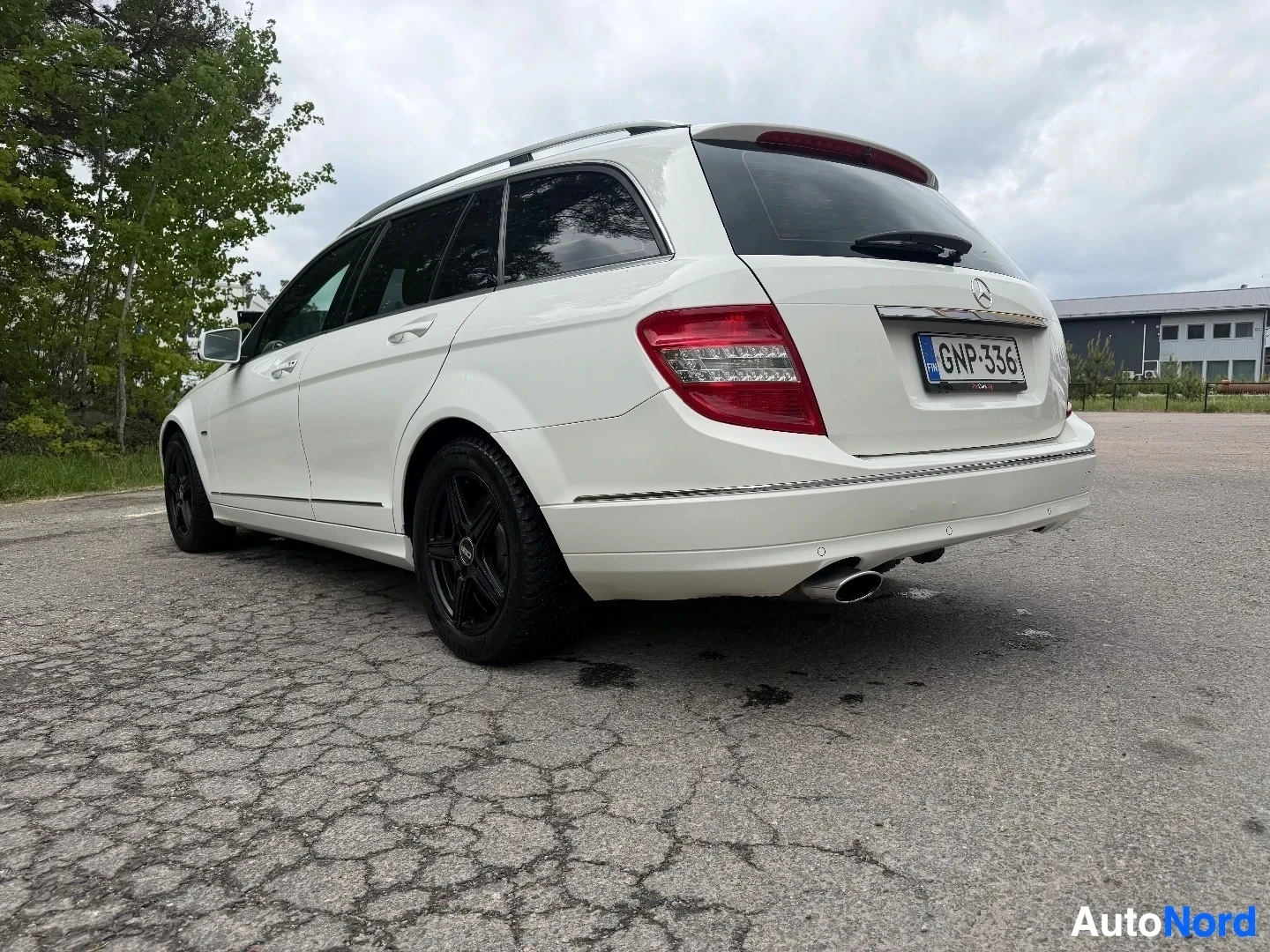 White Mercedes-Benz wagon viewed from rear three-quarter angle