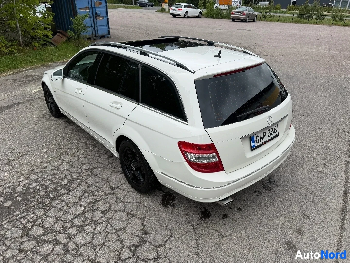 White Mercedes-Benz wagon viewed from above at rear angle