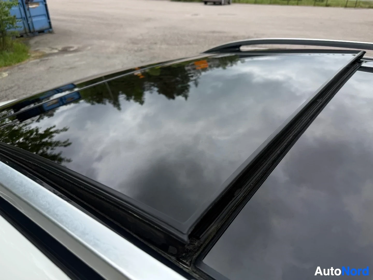 Close-up detail of panoramic sunroof with black frame on wagon roof
