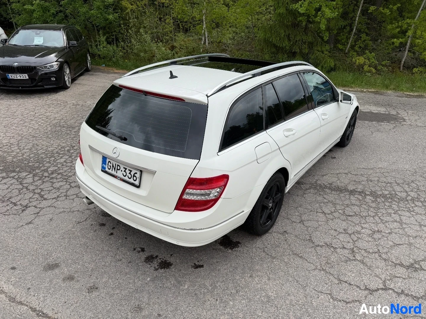 White Mercedes-Benz wagon from above, showing panoramic roof and overall body shape