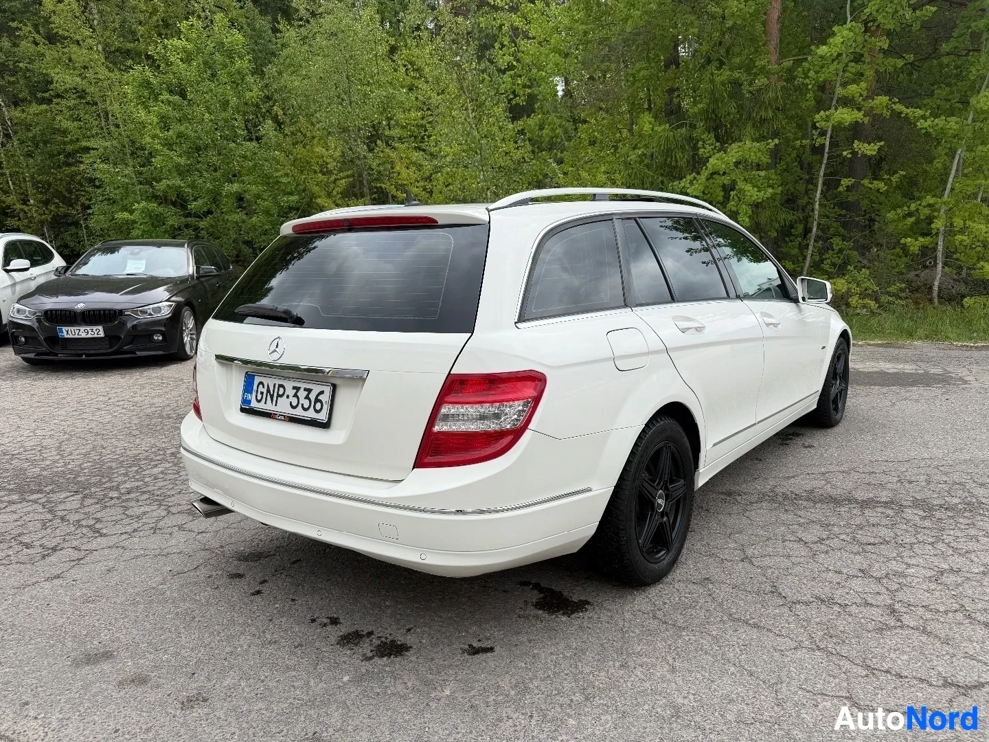White Mercedes-Benz wagon, rear three-quarter view showing taillights and profile