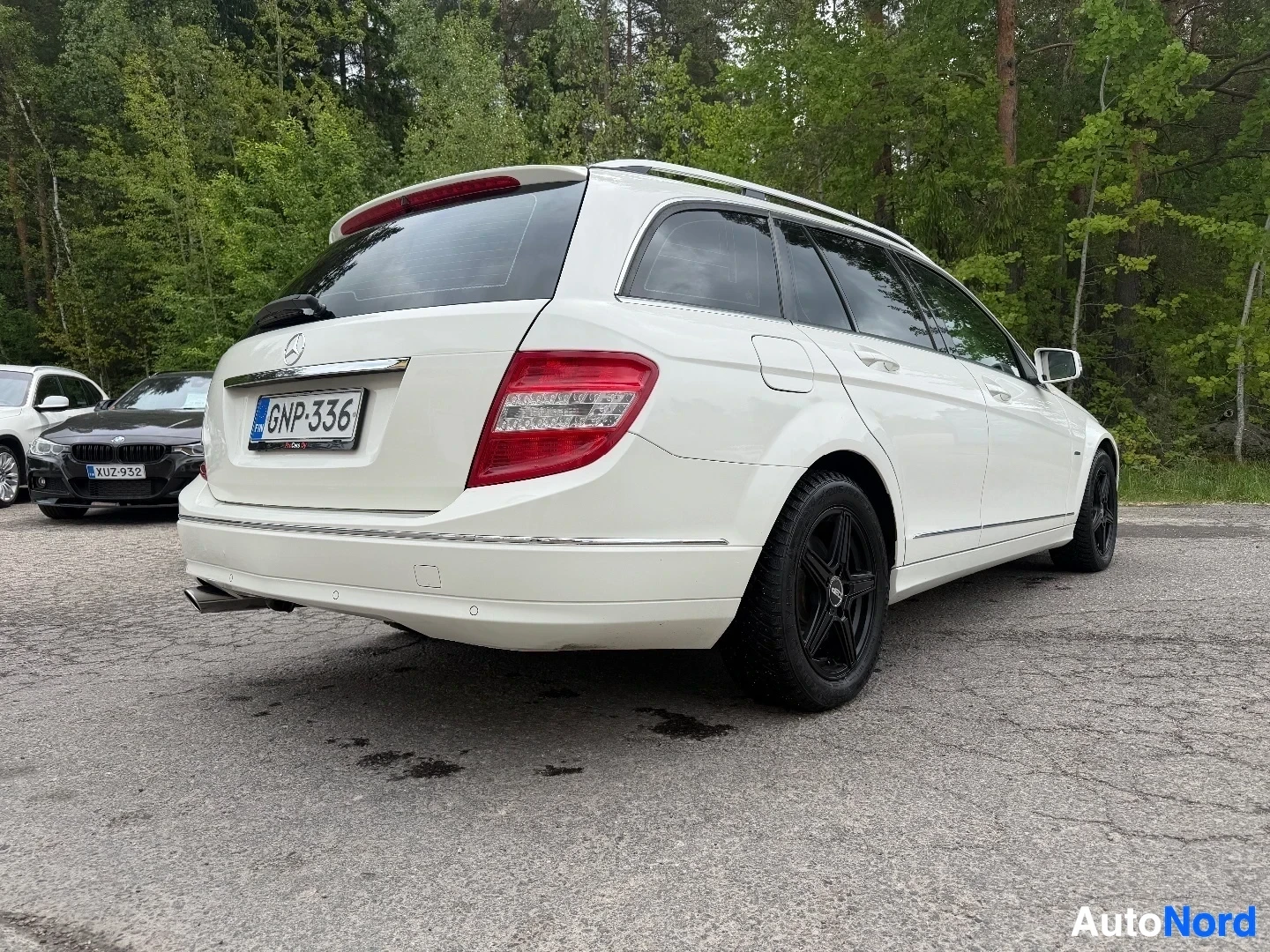 White Mercedes-Benz wagon, rear three-quarter angle showing side profile and rear end