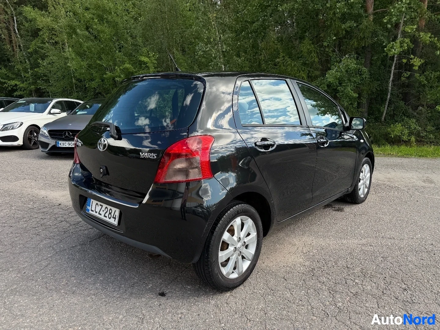 Black Toyota Yaris rear view with hatchback tailgate and lights