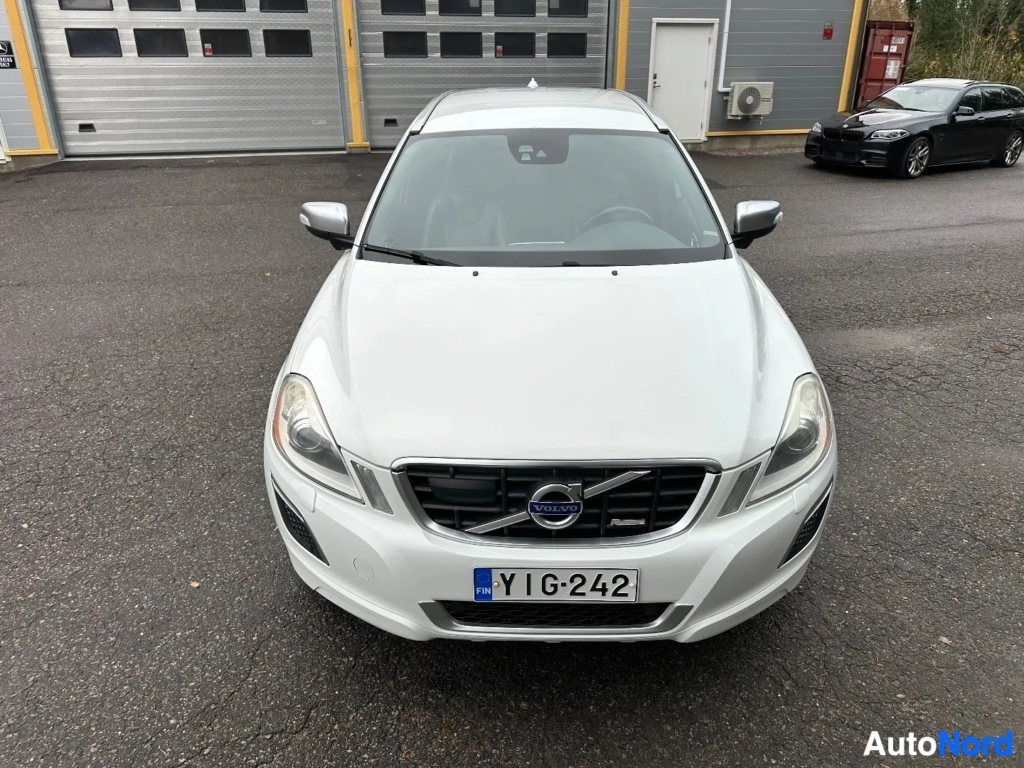 White Volvo XC60 front view in parking lot
