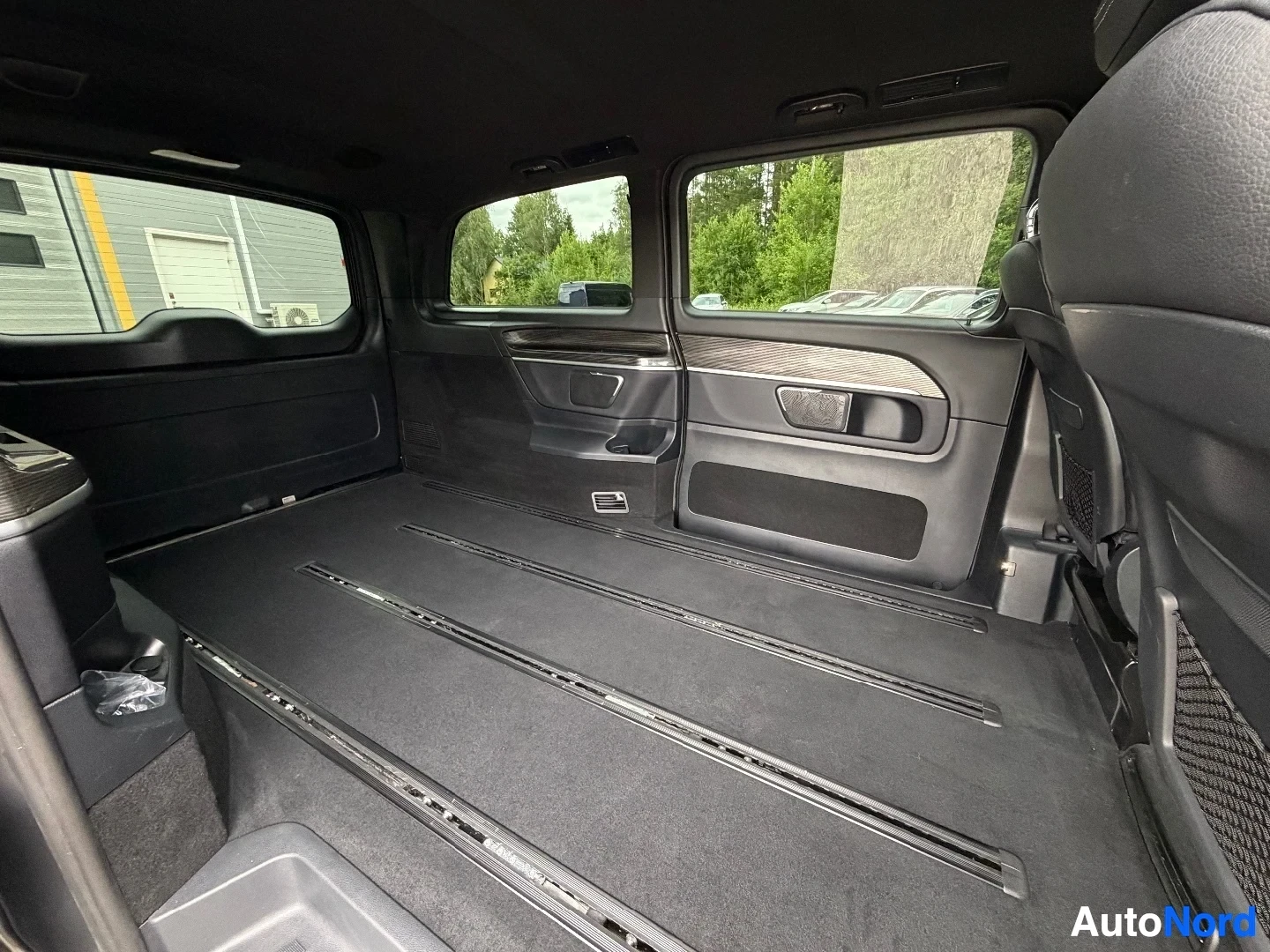 Cargo area interior with windows and side door handles visible