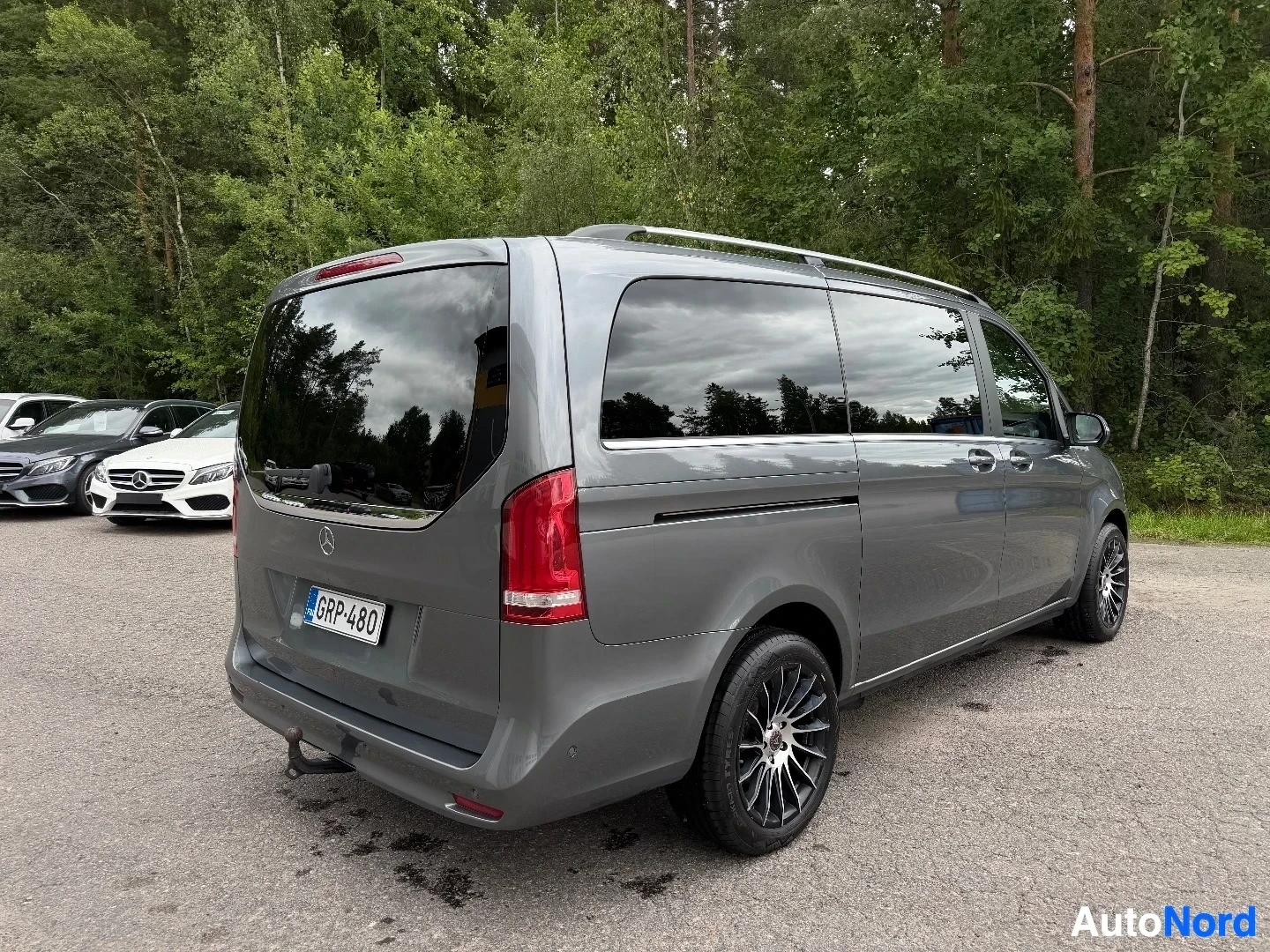 Gray Mercedes-Benz van viewed from rear three-quarter angle in parking lot