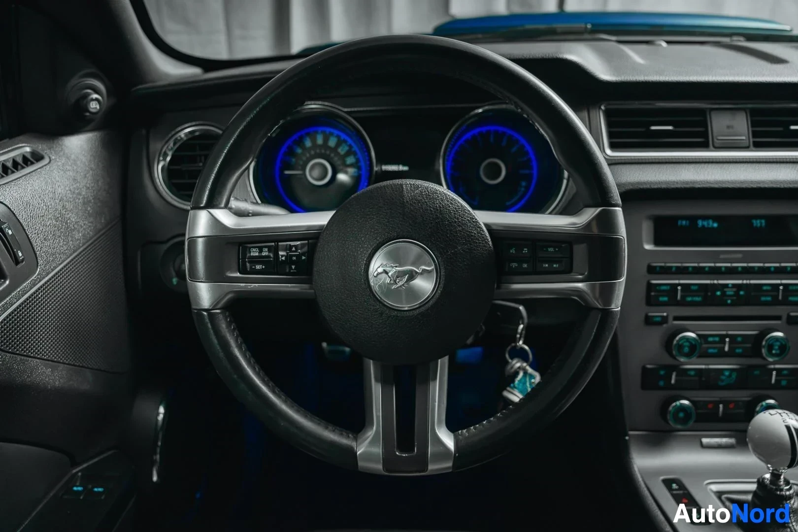 Ohjaamo: Sininen Ford Mustang GT, ohjauspyörä ja sinivalaistu mittaristo