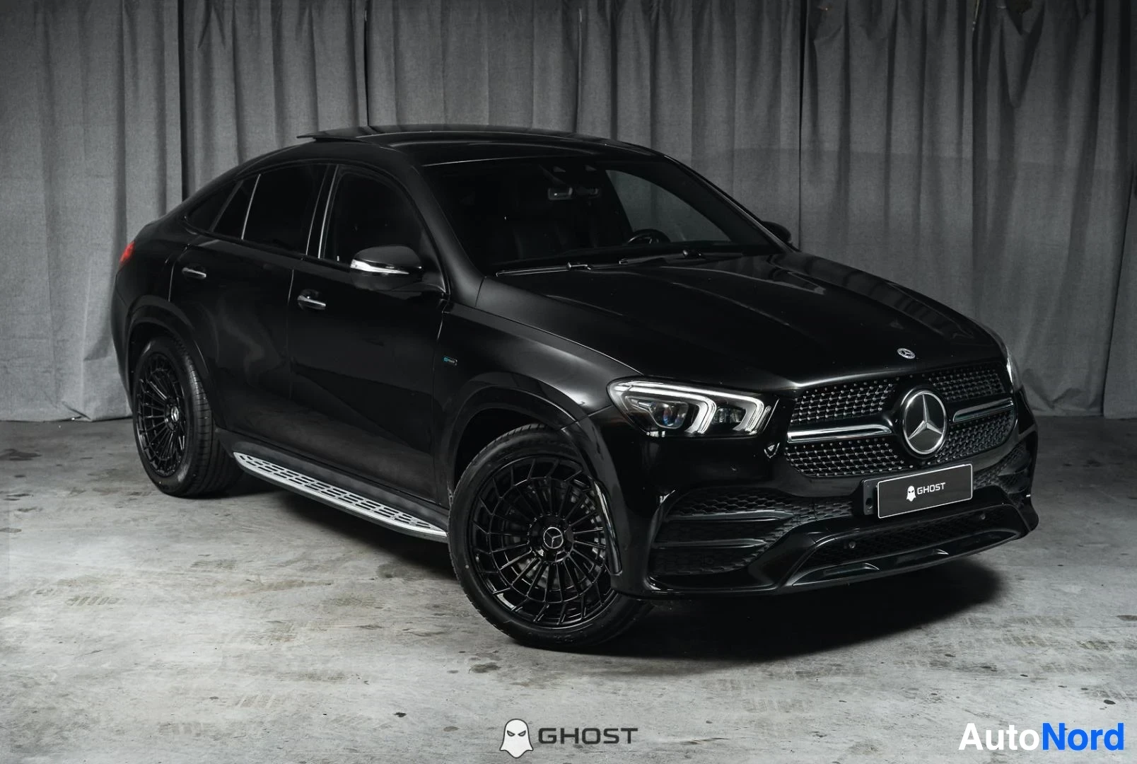 Etuviisto, nokka oikealle: Musta Mercedes-Benz GLE Coupé, koko ajoneuvo näkyvissä, mustat vanteet, studiotausta