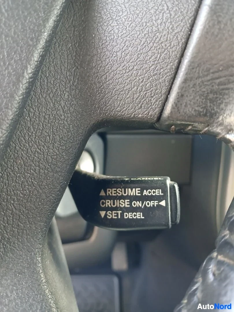 Yksityiskohta: Lähikuva ohjauspyörän oikeanpuoleisesta vivusta, jossa on teksti "^RESUME ACCEL", "CRUISE ON/OFF◀" ja "▼SET DECEL".