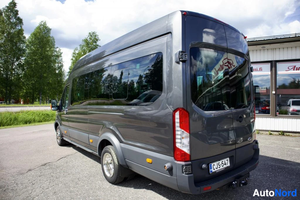 Takaviisto: Tummanharmaa pakettiauto, jossa on takaovet, takavalot ja rekisterikilpi CJ-547, kuvattuna takaviistosta. Autossa on vetokoukku.