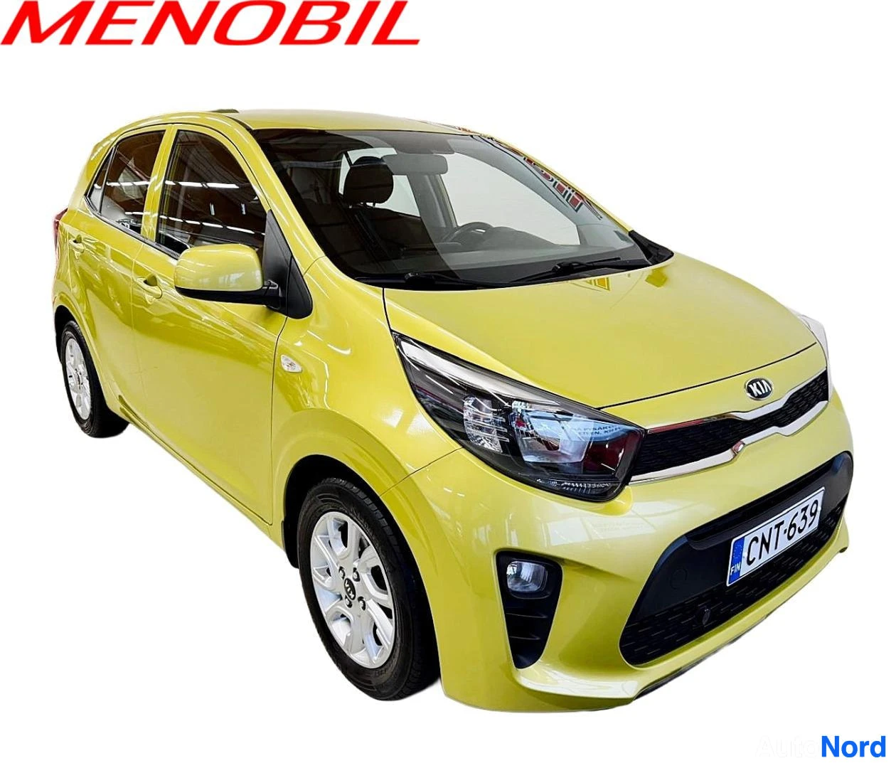 Etuviisto, nokka oikealle: Keltainen Kia Picanto -henkilöauto vinosta edestä, etupuskuri ja rekisterikilpi näkyvät.