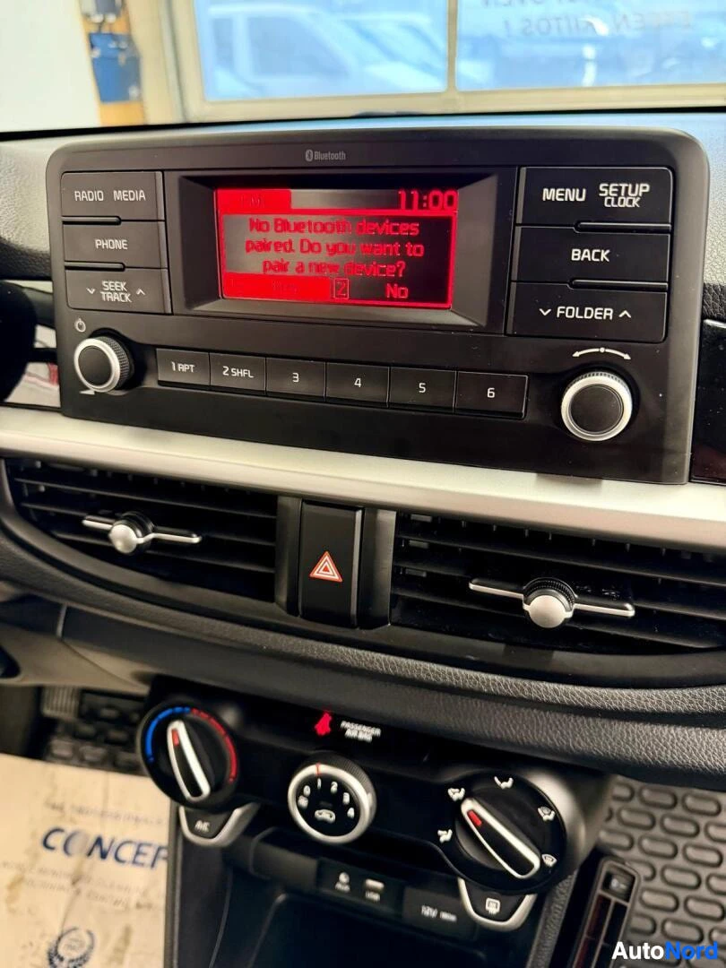 Muu: Kojelaudan lähikuva: radioyksikkö, jonka näytöllä kello 11:00 ja teksti 'No Bluetooth devices paired. Do you want to pair a new device?' sekä RADIO-, MEDIA-, PH