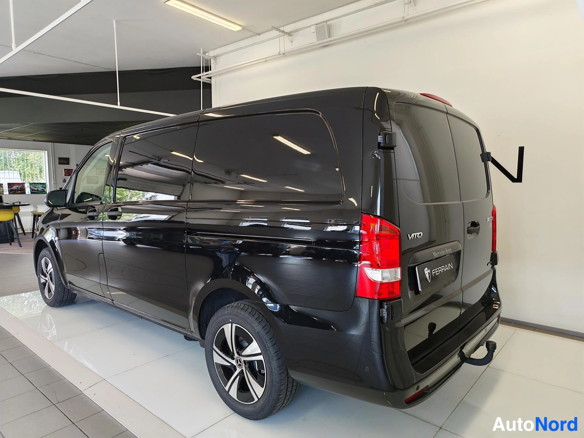 Takaviisto: Mustan Mercedes-Benz Vito -pakettiauton takaosa ja sivu; takaluukussa VITO-teksti, takana vetokoukku.