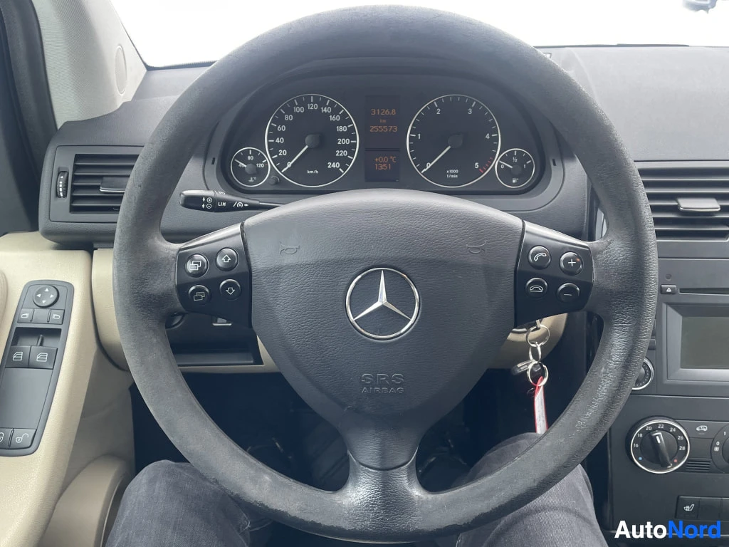 Ohjaamo: Close-up of the interior cockpit showing the leather-wrapped multifunction steering wheel with mounted controls and instrument cluster gauges