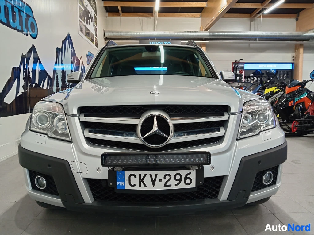 Edestä: Hopeanvärinen Mercedes-Benz GLK edestä kuvattuna, rekisteritunnus, lisävalo kiinnitetty etupuskuriin.