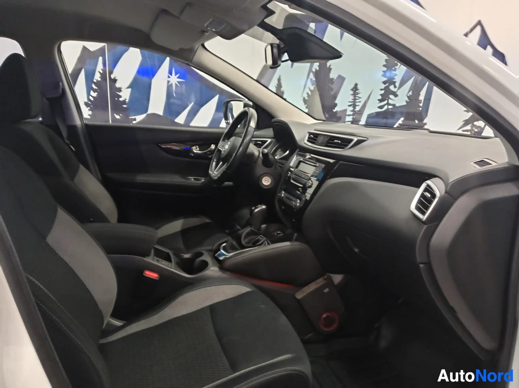 Muu: Takapenkiltä kuvattu näkymä etuistuimiin ja kojetauluun: tummat istuimet, keskikonsoli ja vaihteen vipu.