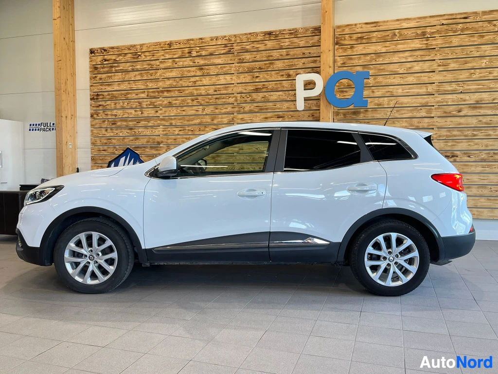 Sivulta: Renault Kadjar, valkoinen auto kuvattuna sivulta sisätiloissa.
