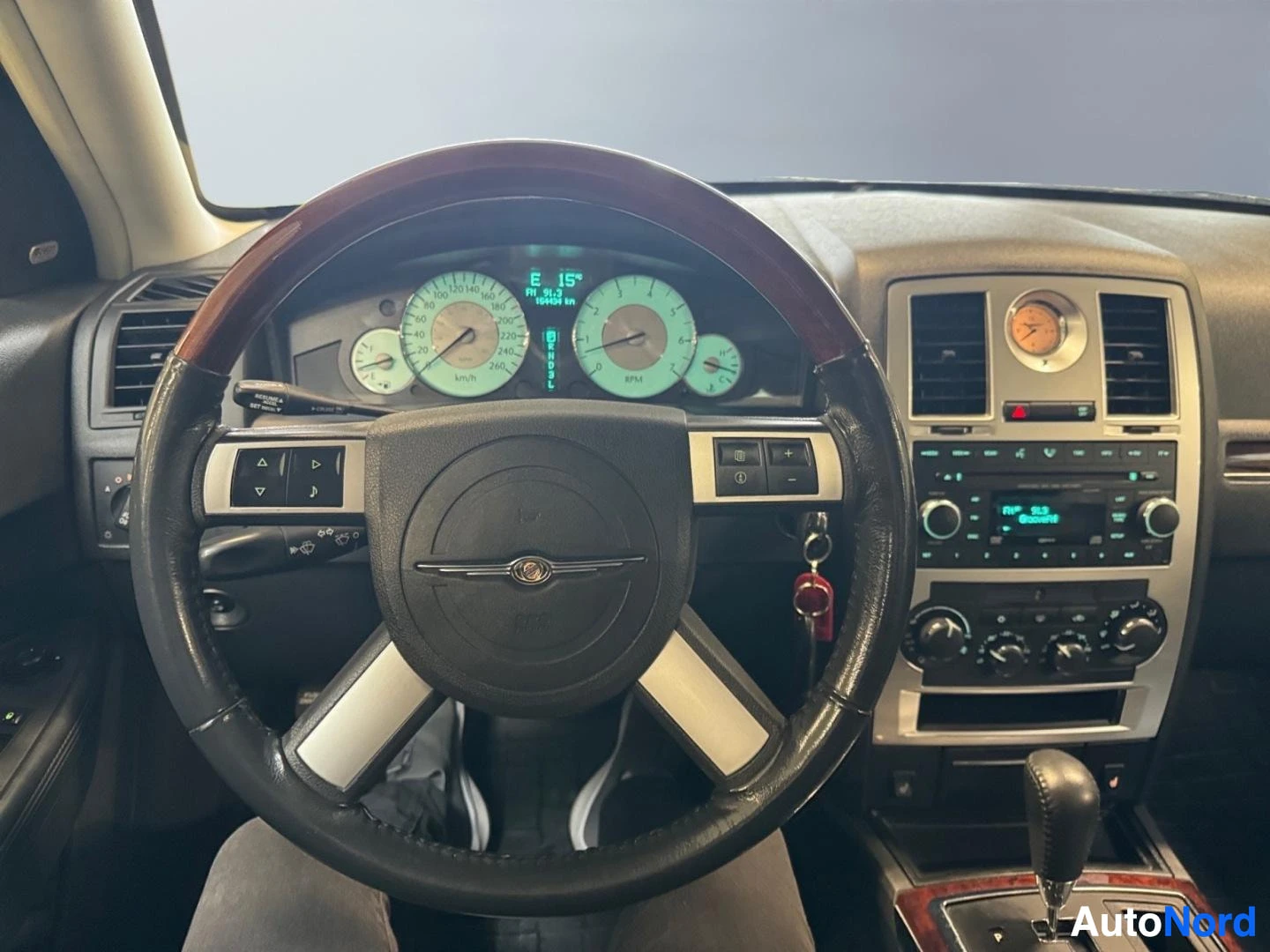 Muu: Chrysler-ohjauspyörä, mittaristo ja keskikonsoli, vaihteenvalitsin ja radio näkyvissä.