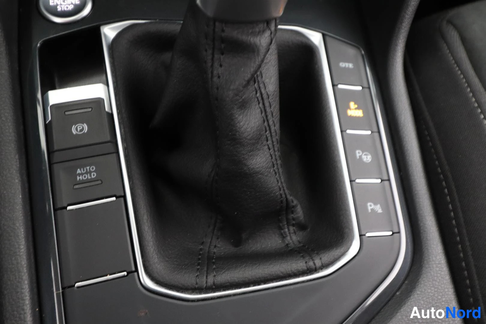 Yksityiskohta: Auton sisätiloissa keskikonsolin vaihtimen ympäristö: elektroninen parkkijarru (P), AUTO HOLD -painike ja parkkeerausavustuksen painikkeet.
