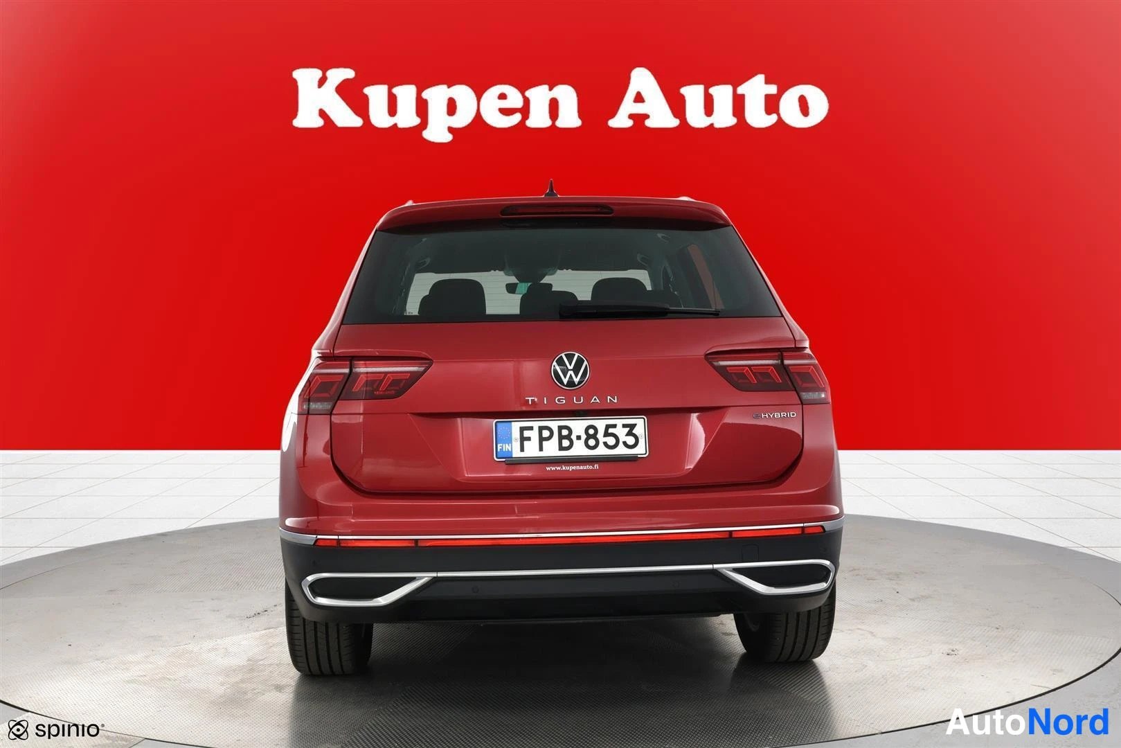 Takaa: Volkswagen Tiguanin takanäkyvys punaisella taustalla, rekisterikilpi