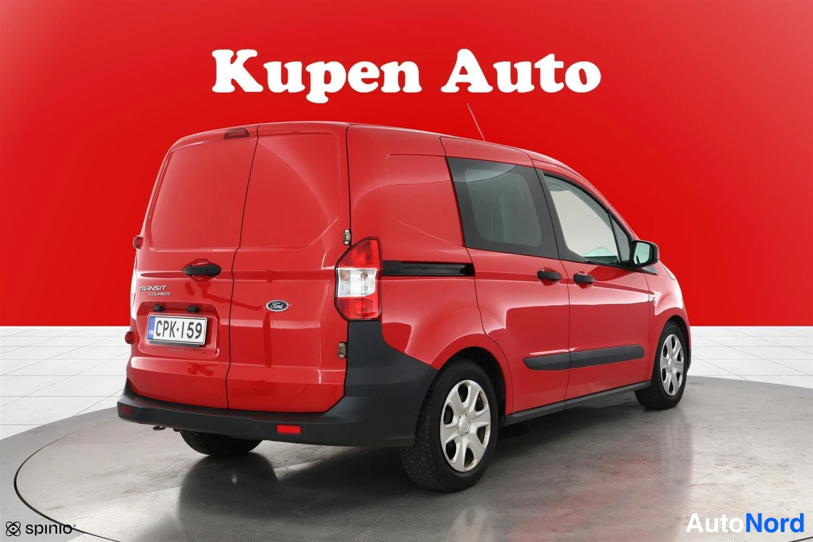 Takaviisto: Punaisen Ford Transit Courierin takakulmanäkyvys oikealta, rekisterikilpi
