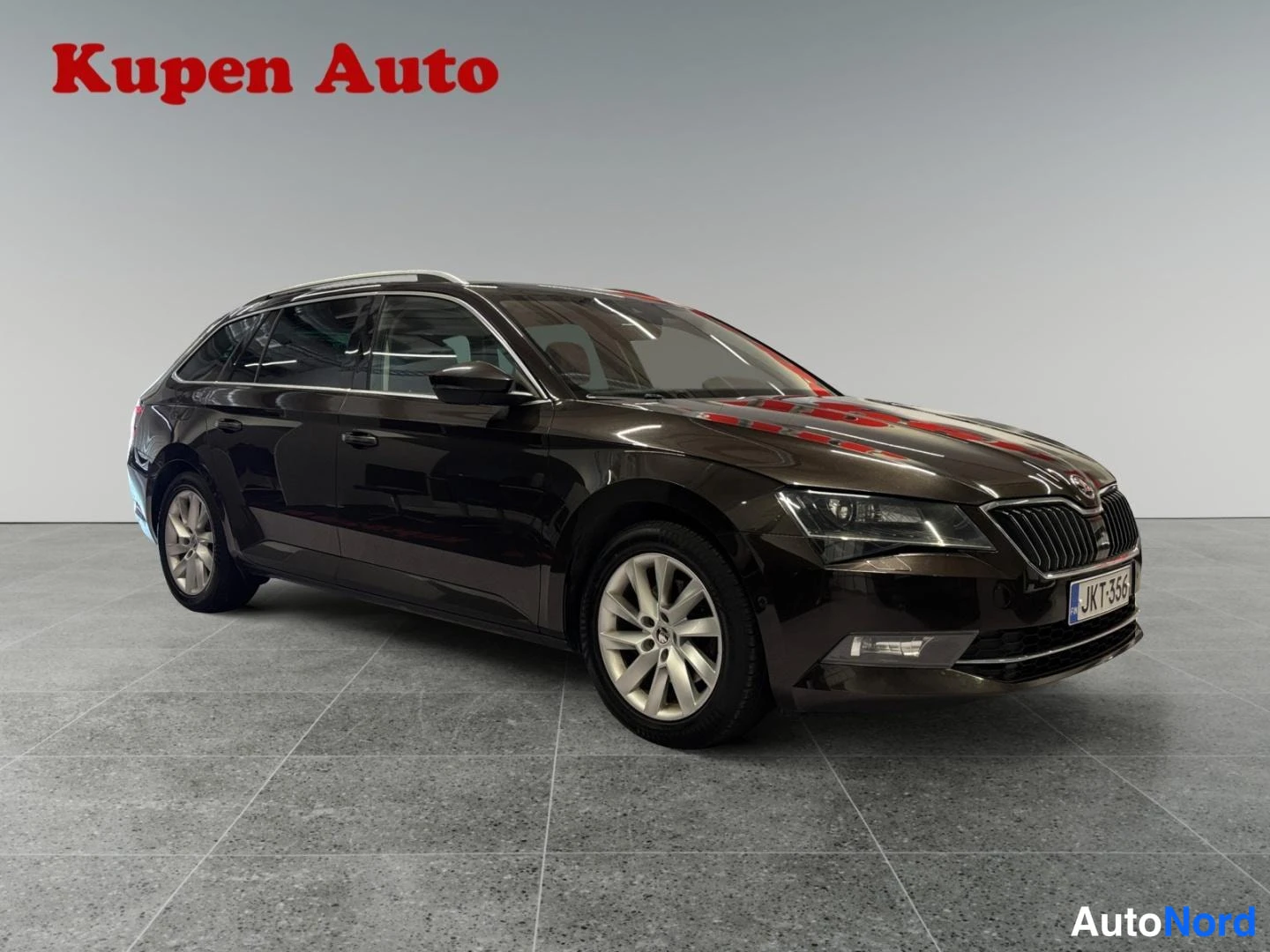 Etuviisto, nokka oikealle: Ruskean Skoda Superb Combin etukolmiveto oikealta sisätiloissa