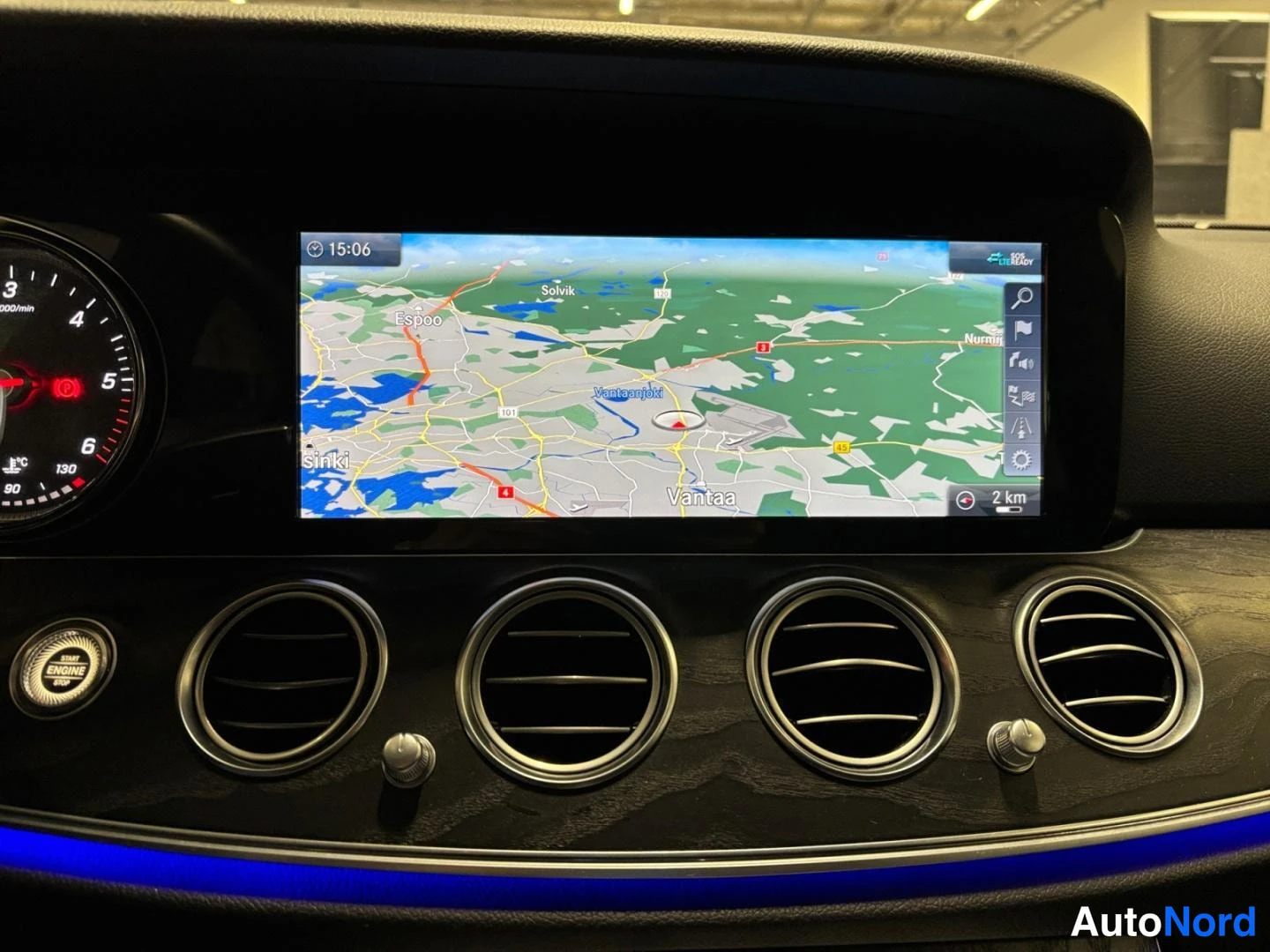 Yksityiskohta: Infotainment-näyttö näyttää karttaa (Espoo, Vantaa), alapuolella ilmastointisuuttimet ja ENGINE-heaterin merkkivalo