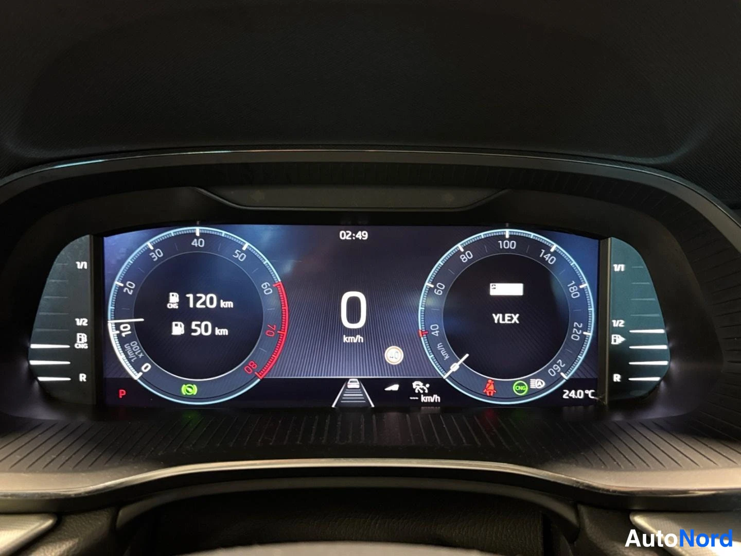 Muu: Digitaalinen mittaristo lähikuvassa: nopeus 0 km/h, kantama 120 km ja 50 km, ulkolämpötila 24,0 °C, vaihde P.