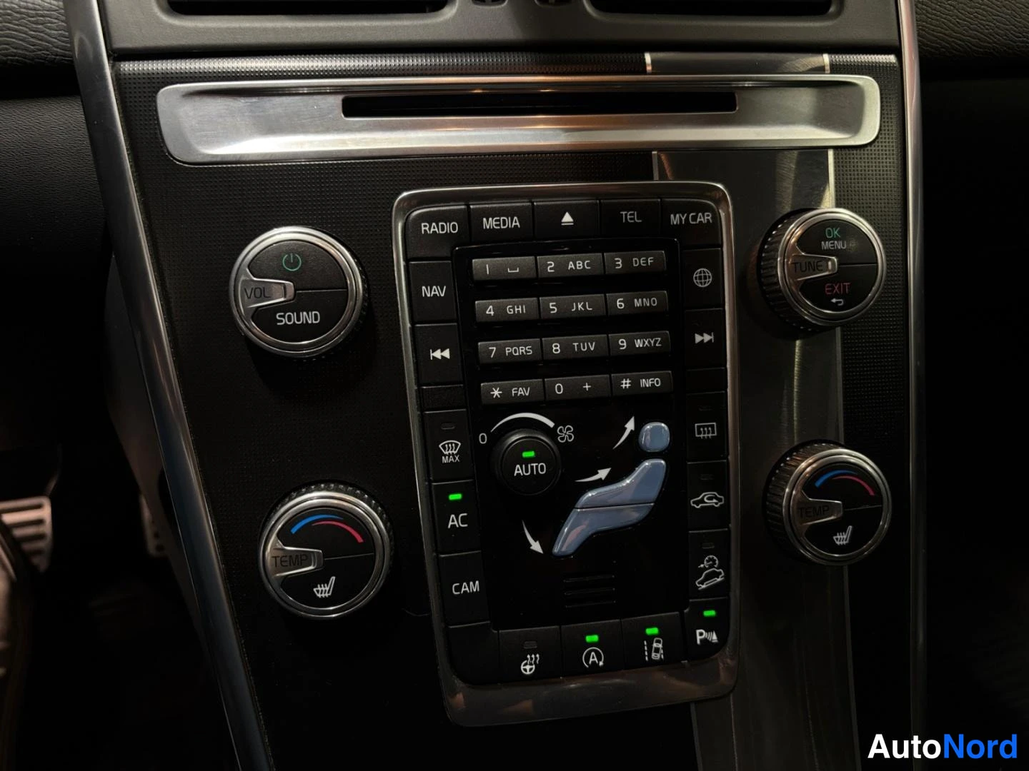 Muu: Kojelaudan keskuskonsolin äänentoisto- ja ilmastointipainikkeet; näkyvissä RADIO, MEDIA, TEL, NAV, AC, CAM, AUTO ja TEMP-SOUND-VOL-säätimet.
