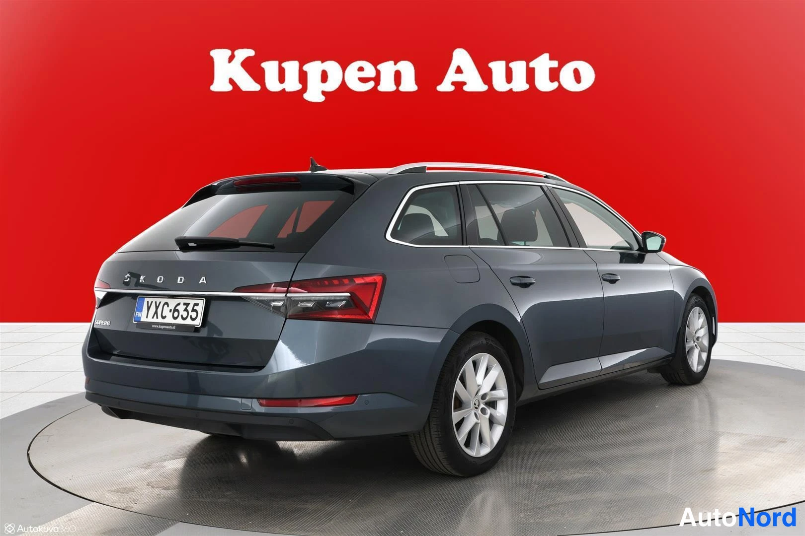 Takaviisto: Skoda Superb -farmari takakulmasta oikealta, tummanharmaa kori ja kattokaiteet.