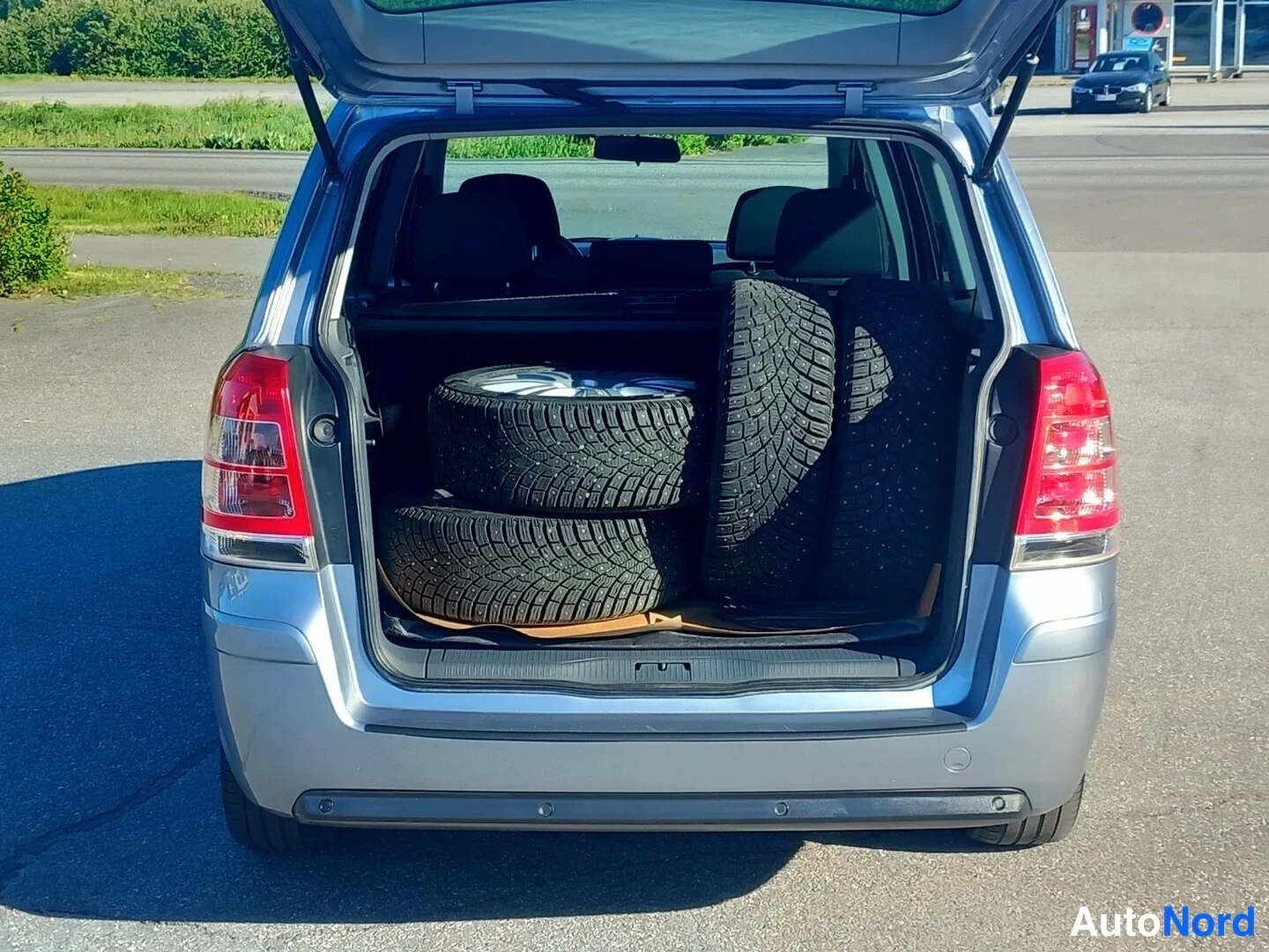 Takaa: Avoimet takaluukut; neljä nokkarellista talvirengasta Opel Zafiran takakontissa.