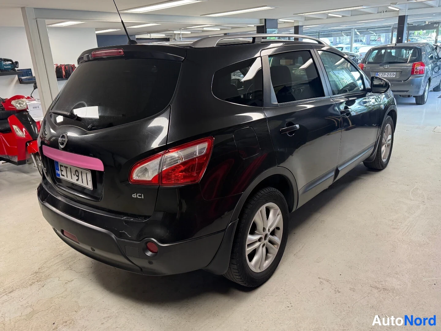 Takaviisto: Nissan Qashqai+2 takakulmasta oikealta, musta, rekisteri, takaluukussa dCi-merkintä.