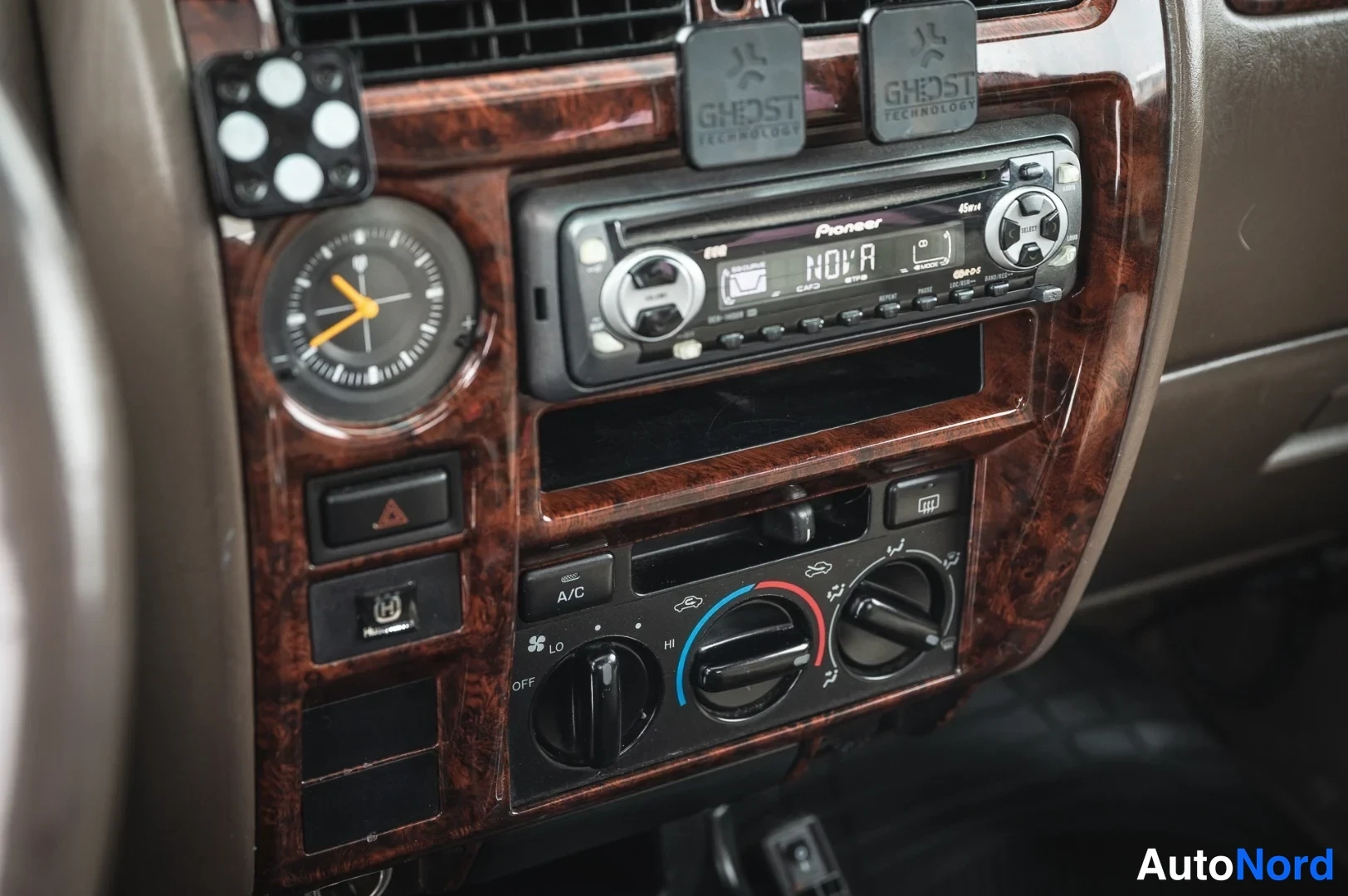 Muu: Kojeiston keskiosa puukiiltisessä paneelissa: Pioneer CD-radio, analoginen kello ja ilmastointiautomaation säätökiekot, joissa näkyy A/C-merkintä.