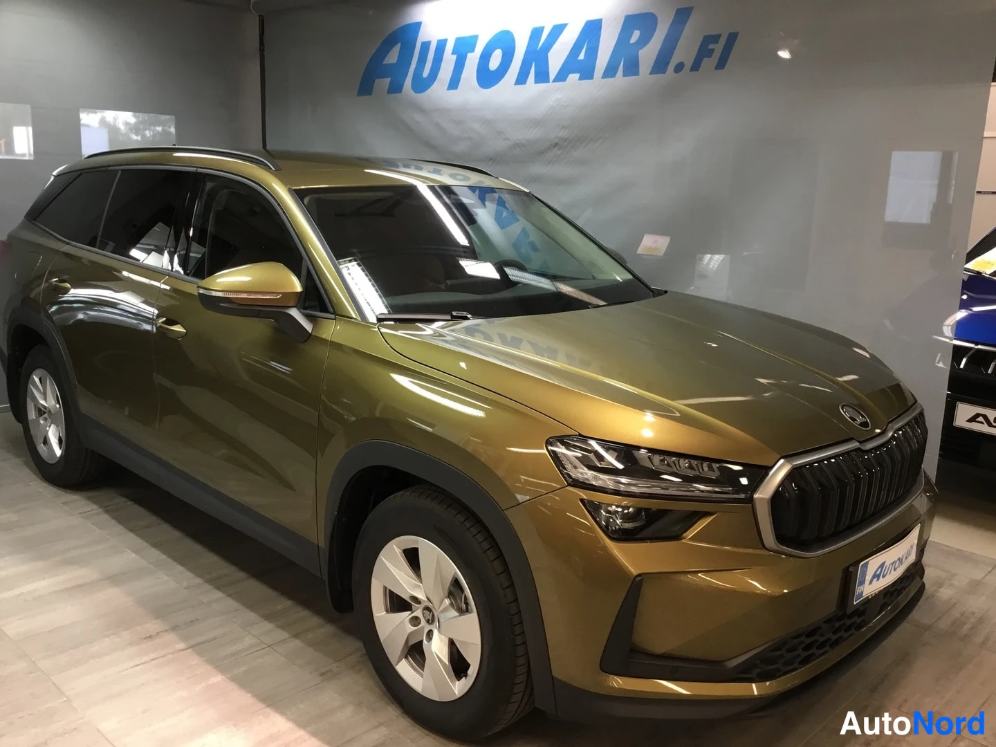 Etuviisto, nokka oikealle: Skoda Kodiaq -farmarityyppinen SUV oliivinvihreällä maalipinnalla nähtäväksi etukolmannelta oikealta, näkyvät etusäleikkö, LED-ajovalot ja mustat muovili