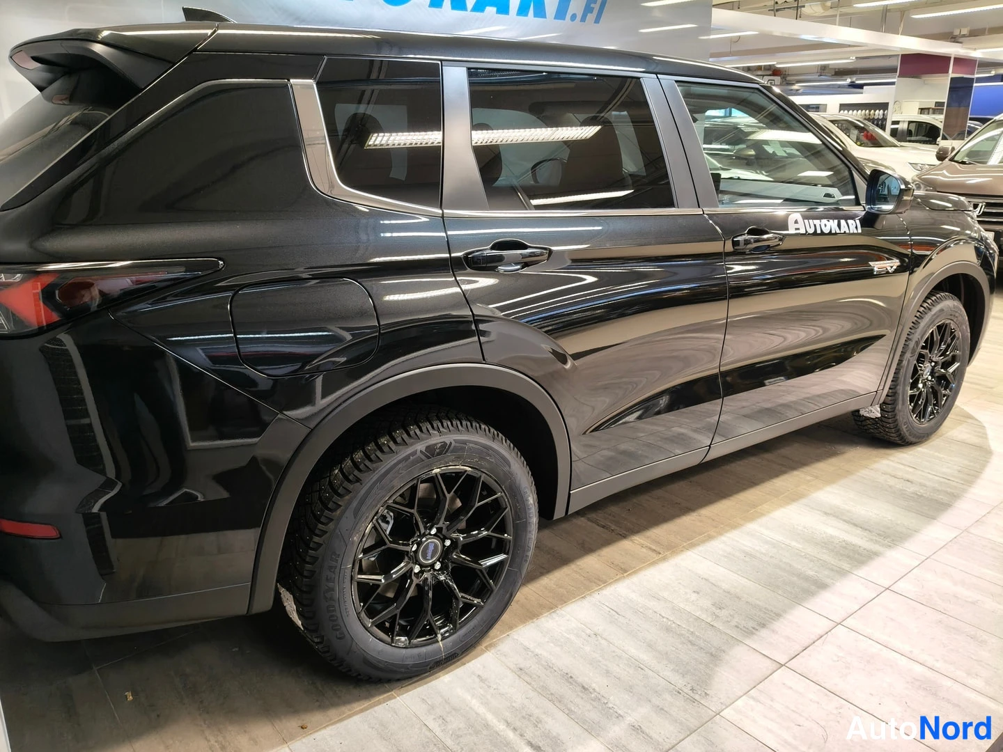 Takaviisto: Mustan SUV-auton sivuprofiili takaa kuvattuna