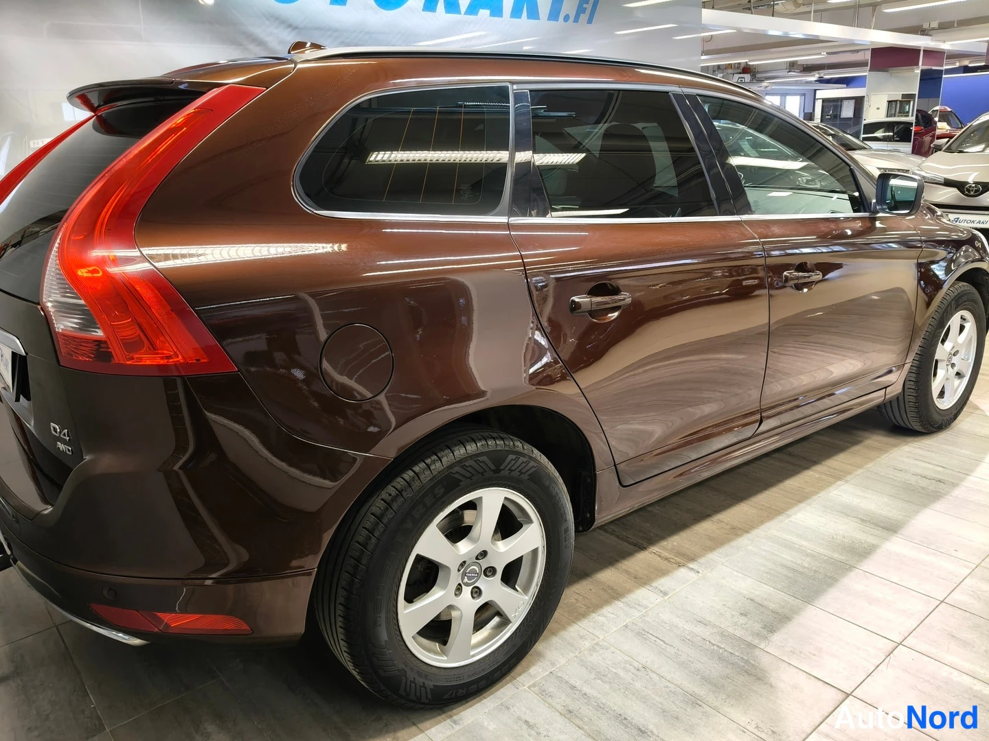 Takaviisto: Auton takakulmanäkymä vasemmalta: ruskean roofan kylki ja takavalot, D4 AWD -merkinnät takana.