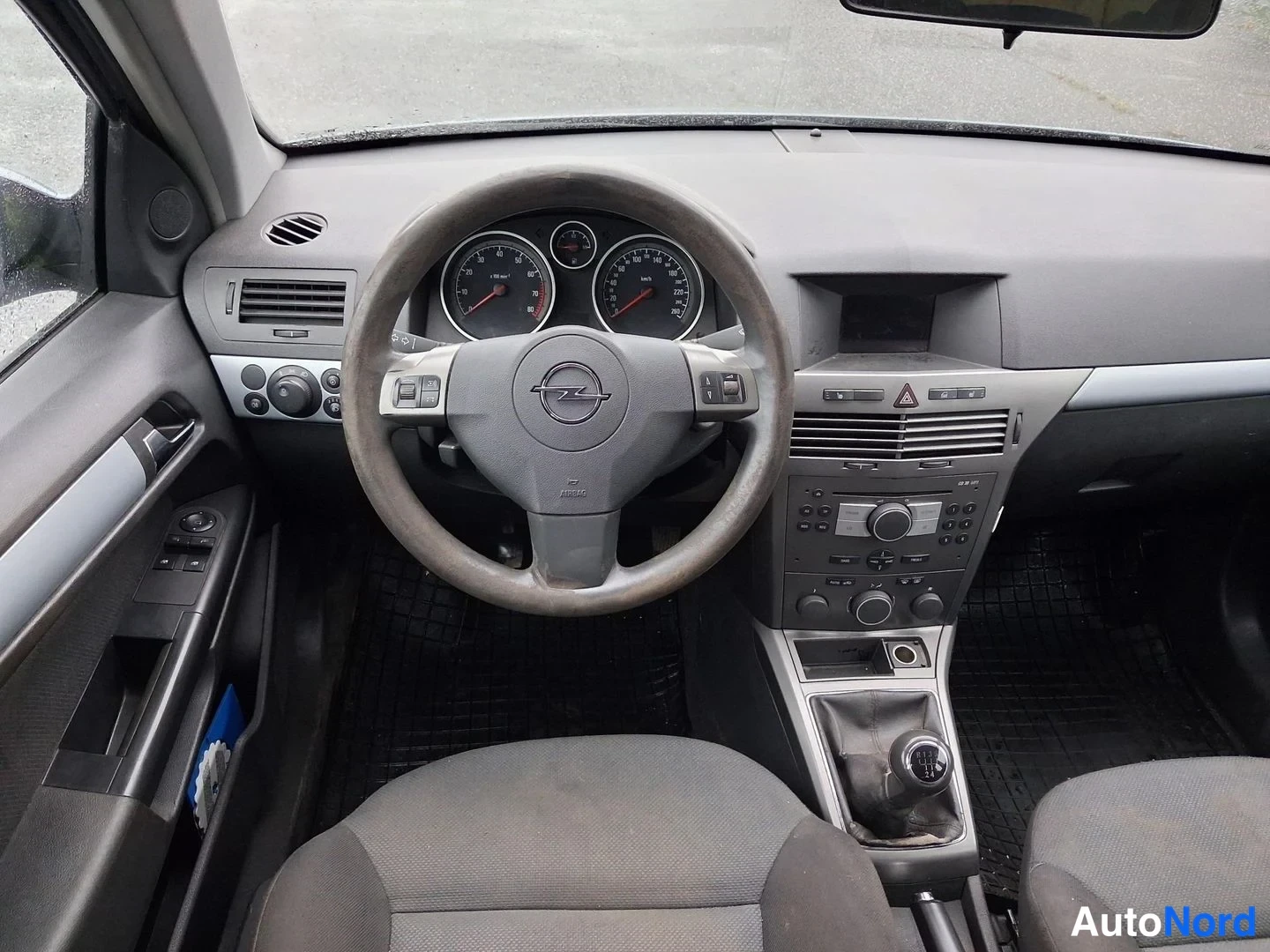 Muu: Opel Astran sisätilat: ohjauspyörä ja mittaristo, manuaalivaihteisto, keskikonsolin radio ja ilmastointilaitteet.