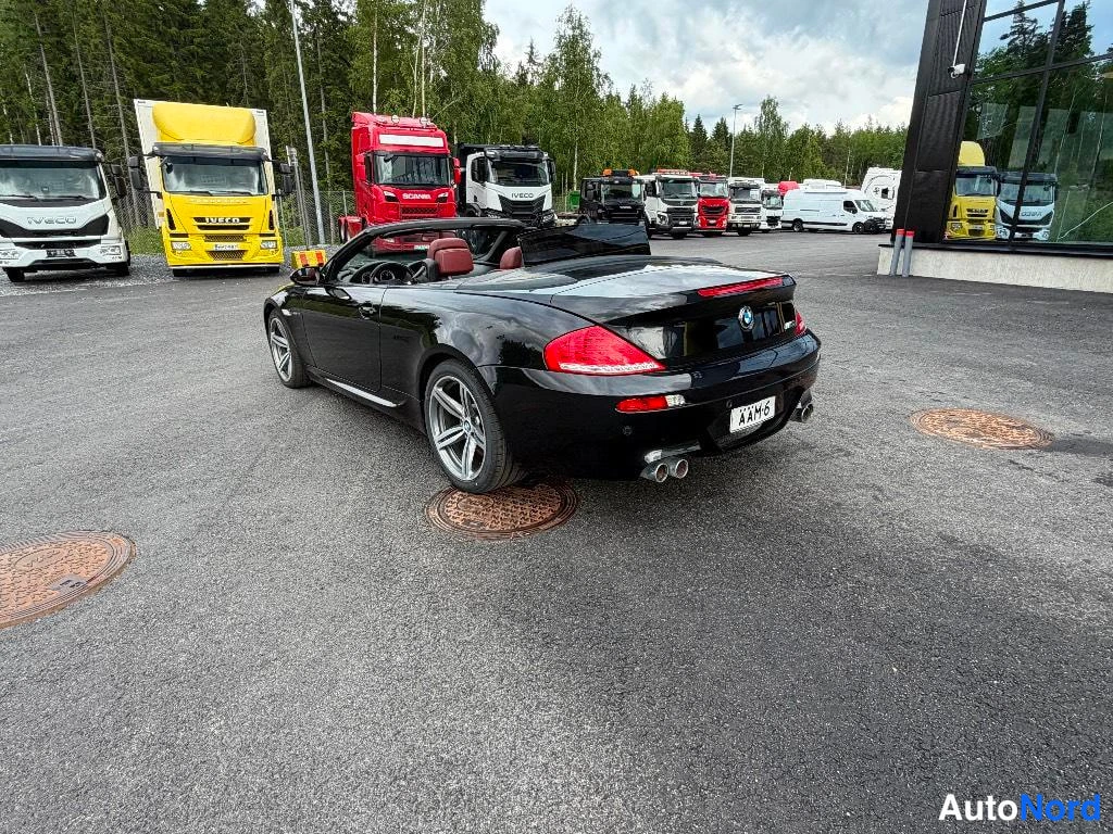 Takaviisto: BMW M6-avonaisen auton takakulmanäkymä; musta koripelti ja avattu katto, rekisterikilpi.