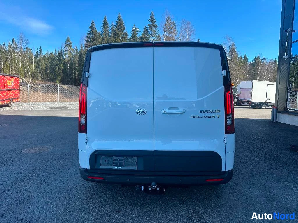 Takaa: Valkoinen Maxus Deliver 7 pakettiauto suoraan takapäältä päin.