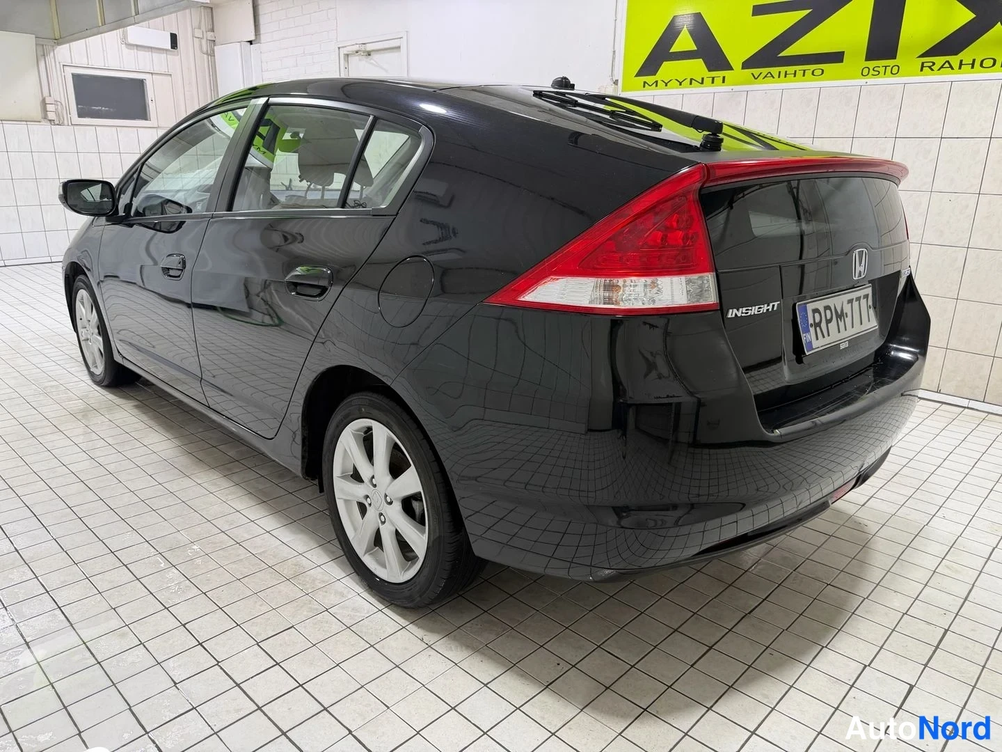 Takaviisto: Mustan Honda Insightin takakulma, INSIGHT-teksti ja rekisterikilpi näkyvät.