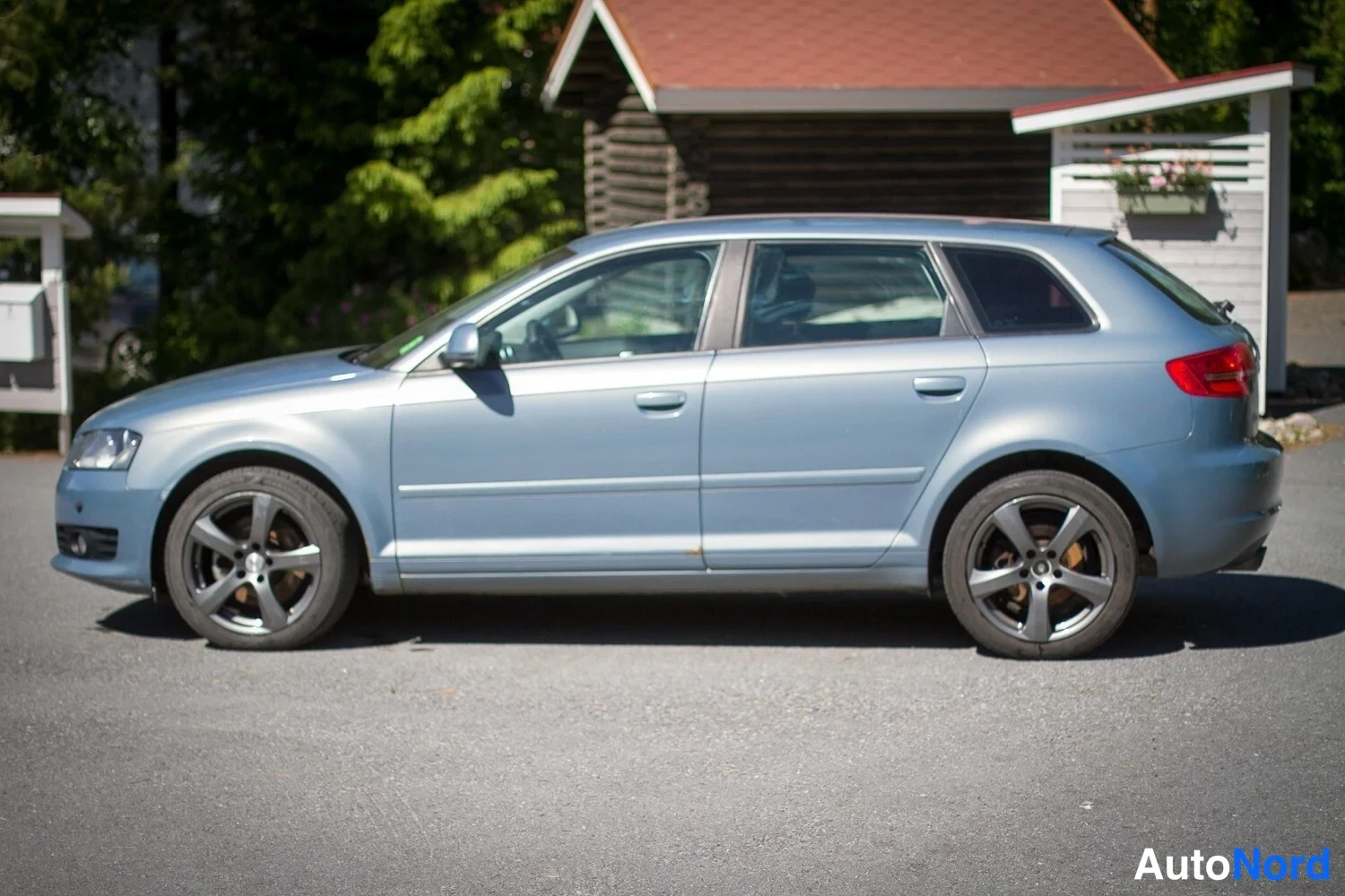 Sivulta: Audi A3 Sportback sivukuvassa oikealta puolen, harmaansininen koriväri ja kevytmetallivanteet.